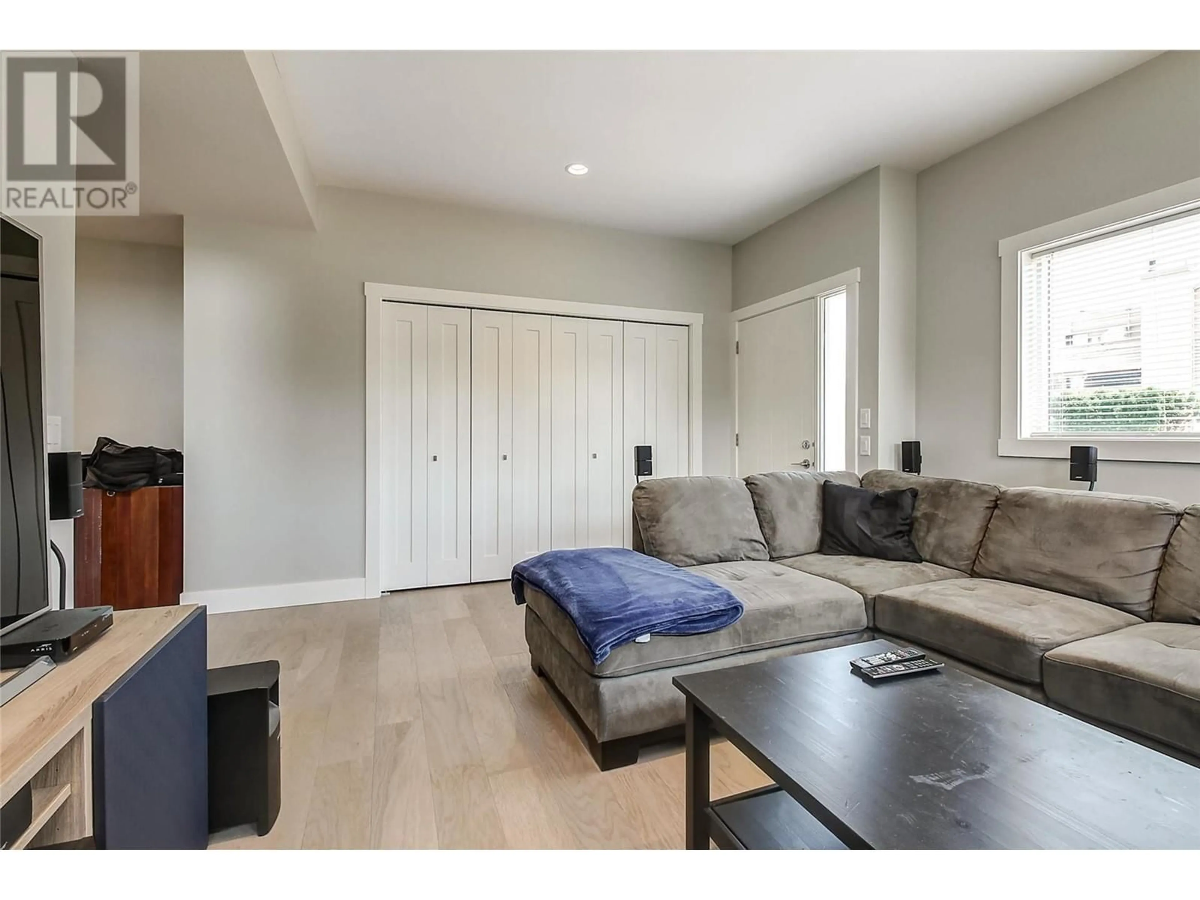 Living room with furniture, wood/laminate floor for 1480 INKAR ROAD, Kelowna British Columbia V1Y5W1