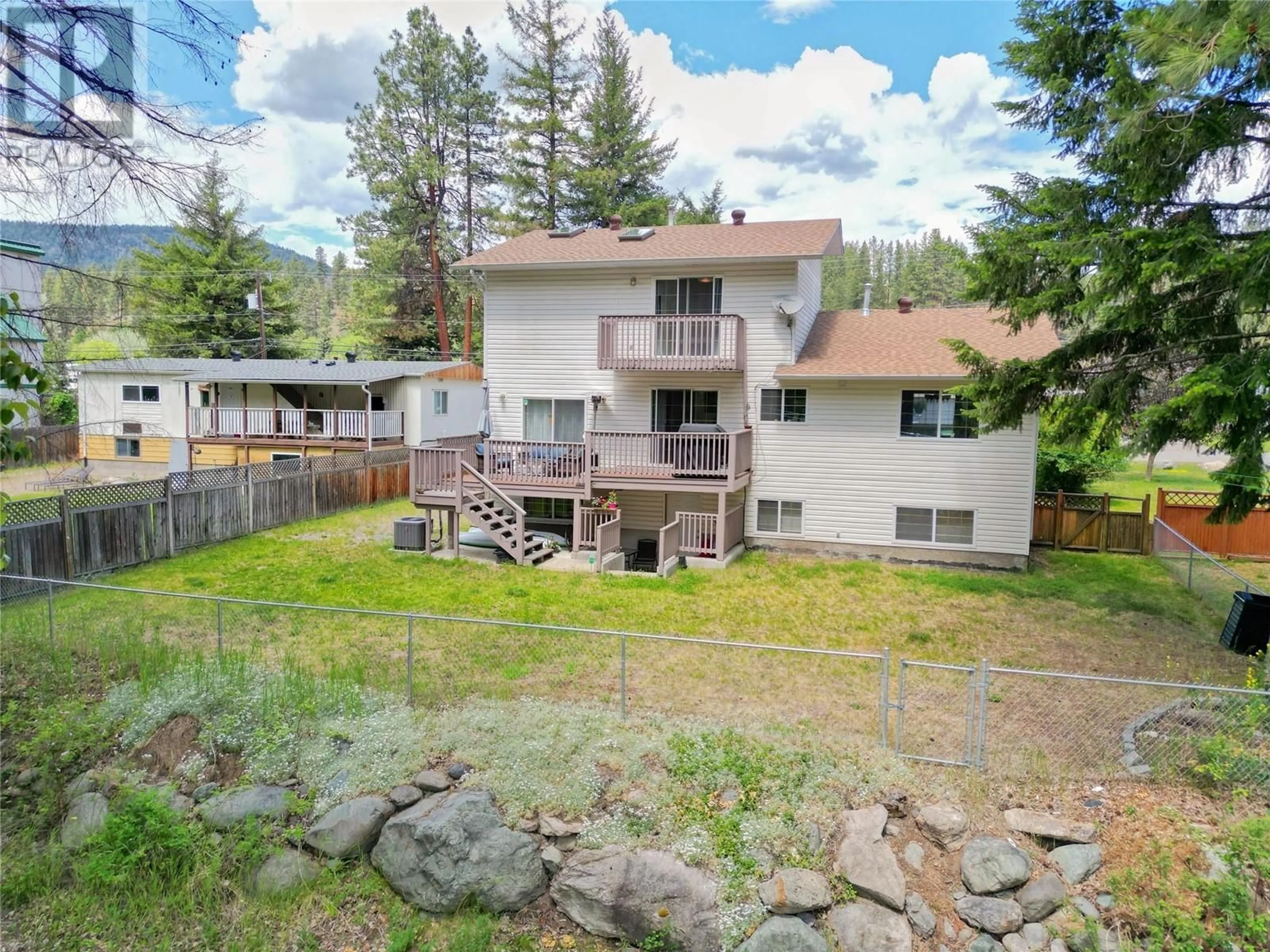 Frontside or backside of a home, the fenced backyard for 454 CORINA Avenue, Princeton British Columbia V0X1W0