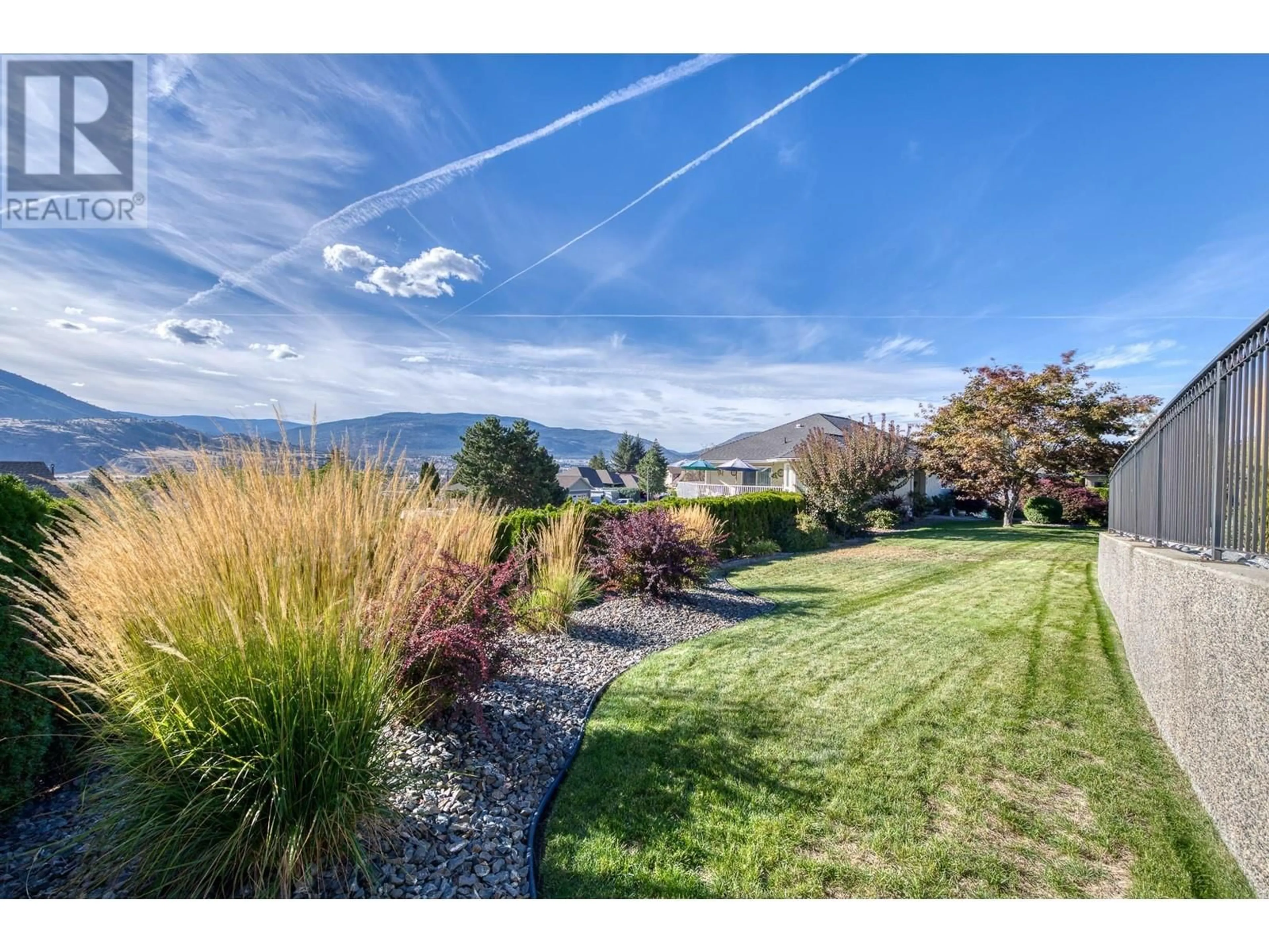 A pic from exterior of the house or condo, the fenced backyard for 188 Gardner Court Court, Penticton British Columbia V2A8N6