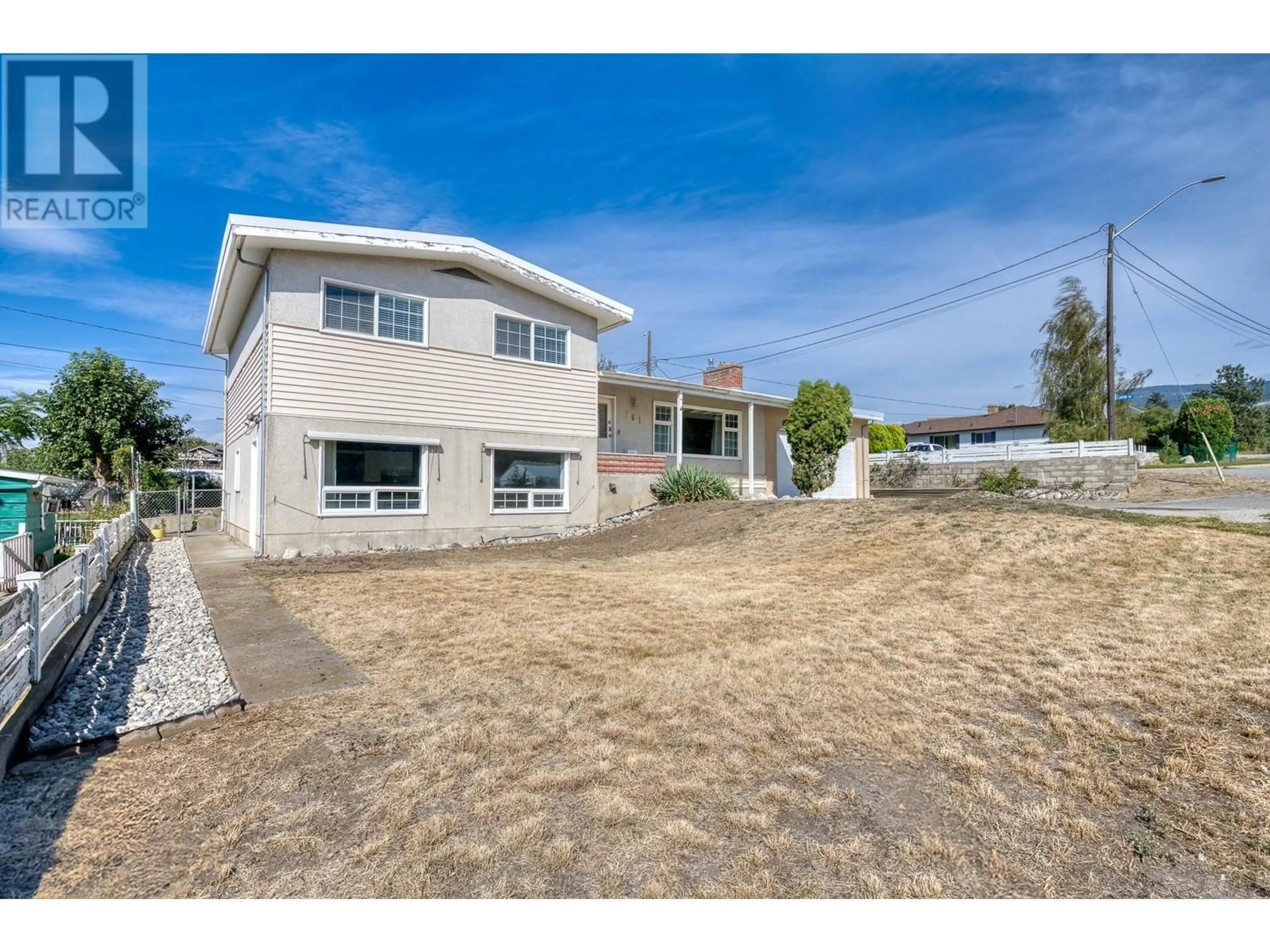 Frontside or backside of a home, the fenced backyard for 781 CARMI Avenue, Penticton British Columbia V2A3G9