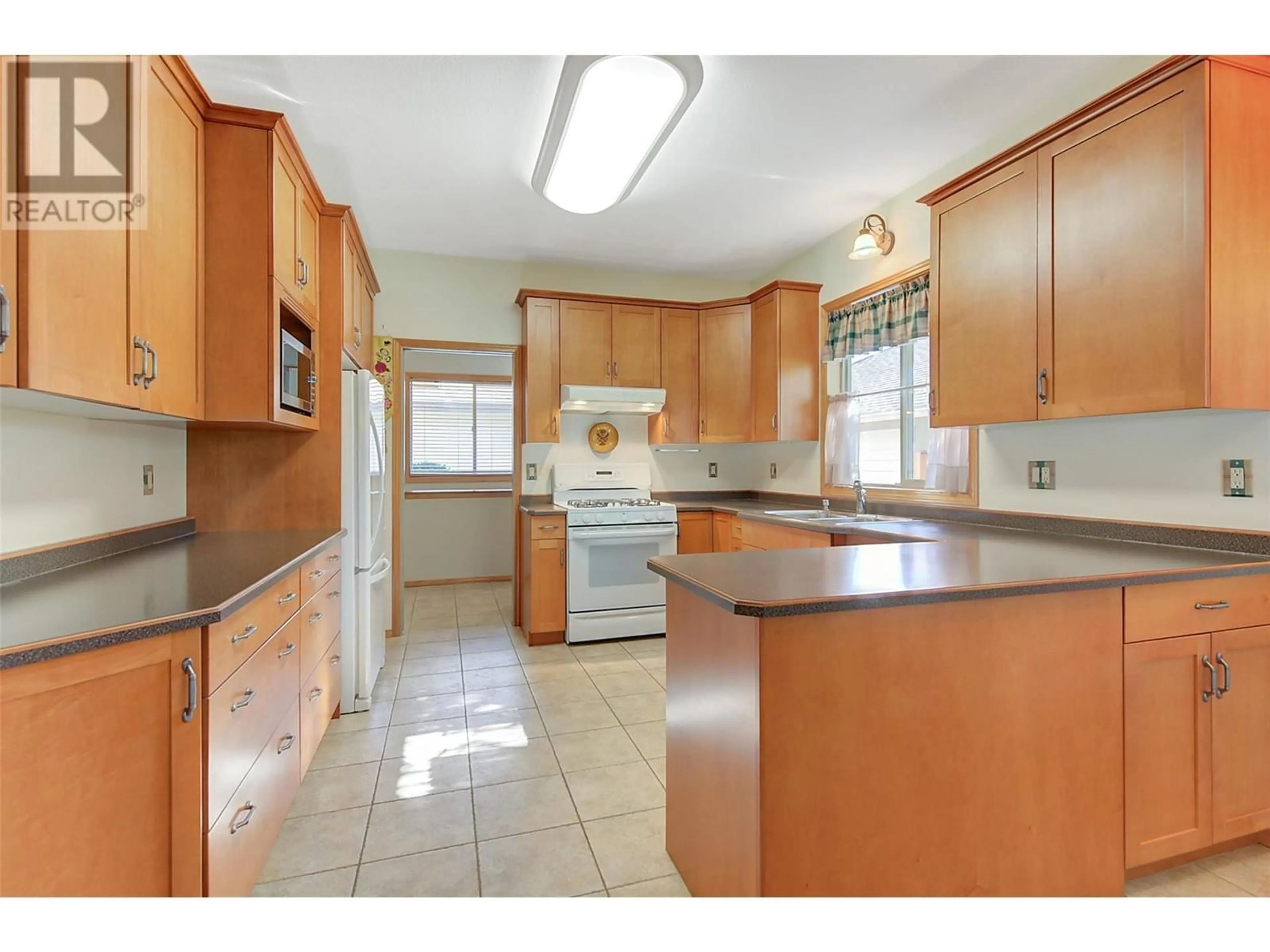 Kitchen, wood floors for 5178 Morrison Crescent, Peachland British Columbia V0H1X2