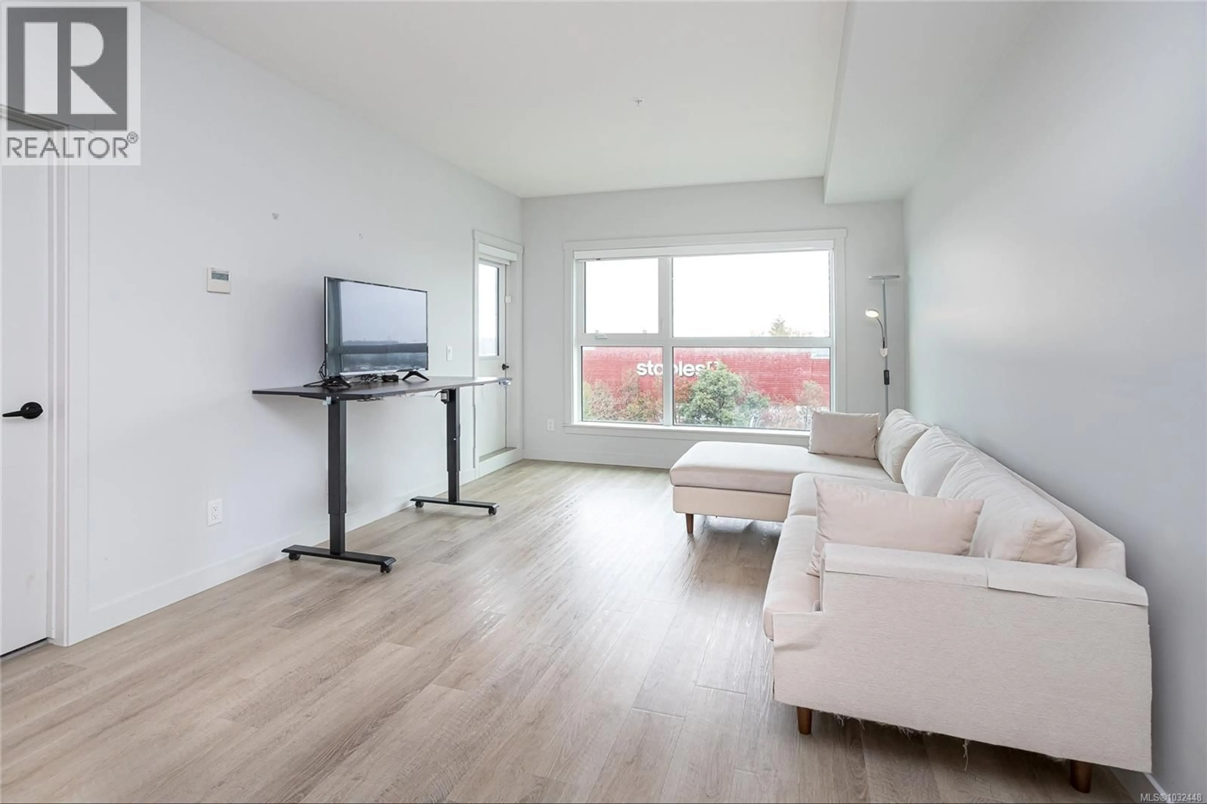 Living room with furniture, wood/laminate floor for 203 - 2469 GATEWAY ROAD, Langford British Columbia V9B6R7