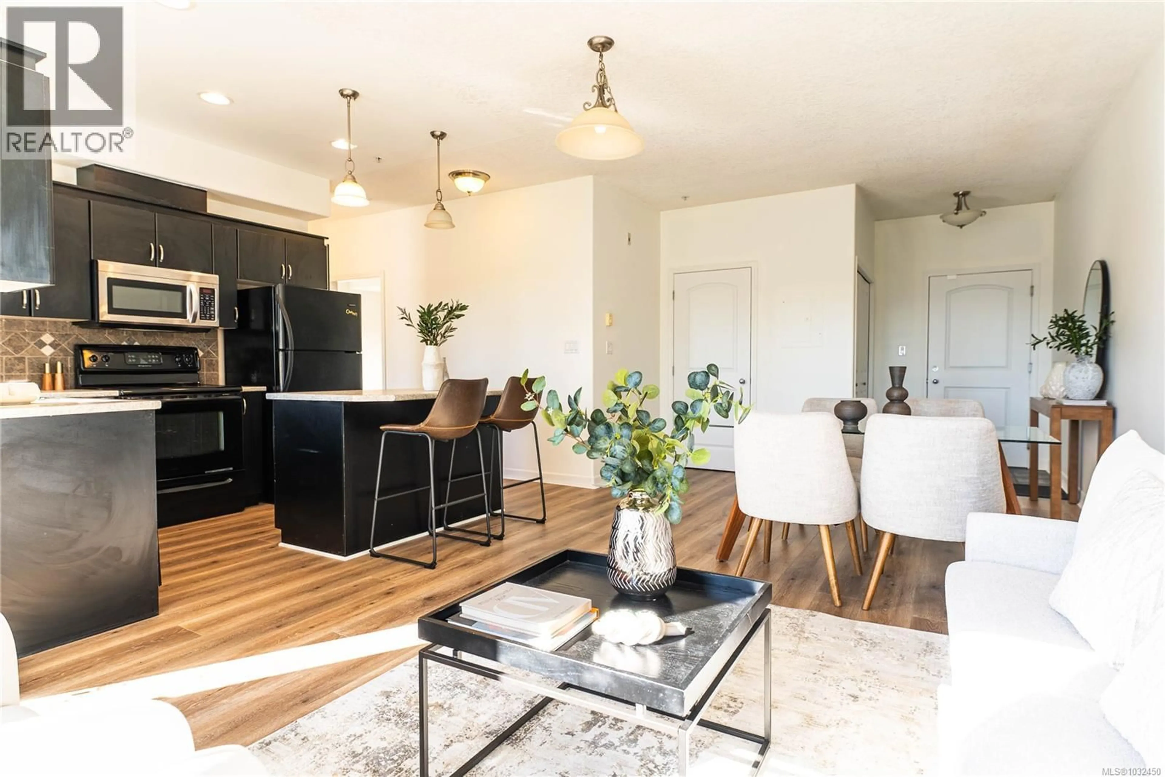 Open concept kitchen, wood/laminate floor for 209 - 3915 CAREY ROAD, Saanich British Columbia V8Z4E3