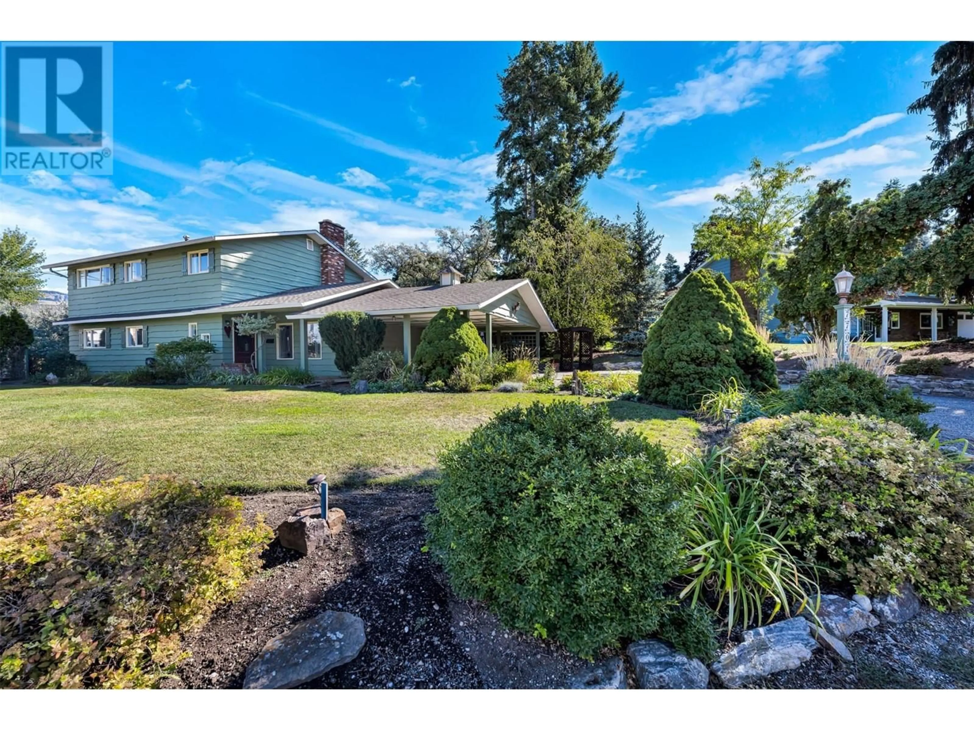 Frontside or backside of a home, the fenced backyard for 7701 Holtam Drive, Coldstream British Columbia V1B1T5