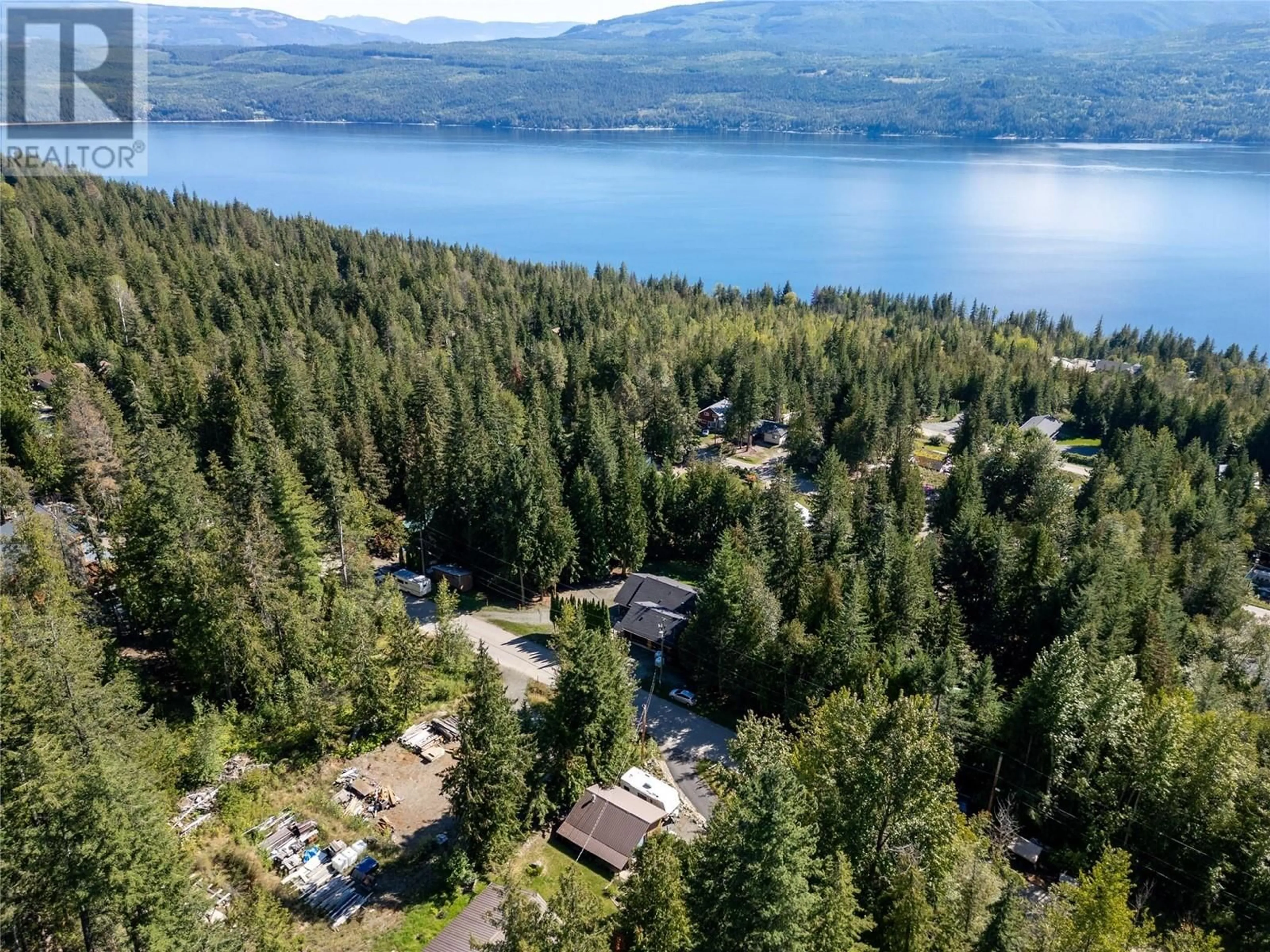 A pic from outside/outdoor area/front of a property/back of a property/a pic from drone, water/lake/river/ocean view for 7438 Anglemont Drive, Anglemont British Columbia V0E1M8