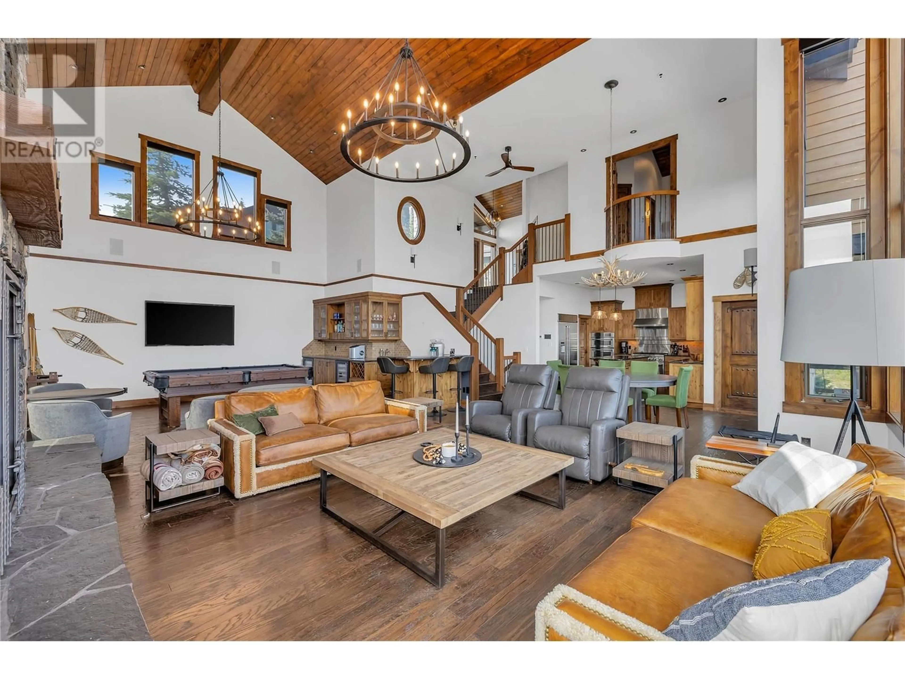 Living room with furniture, wood/laminate floor for 620 Feathertop Way, Big White British Columbia V1P1P3