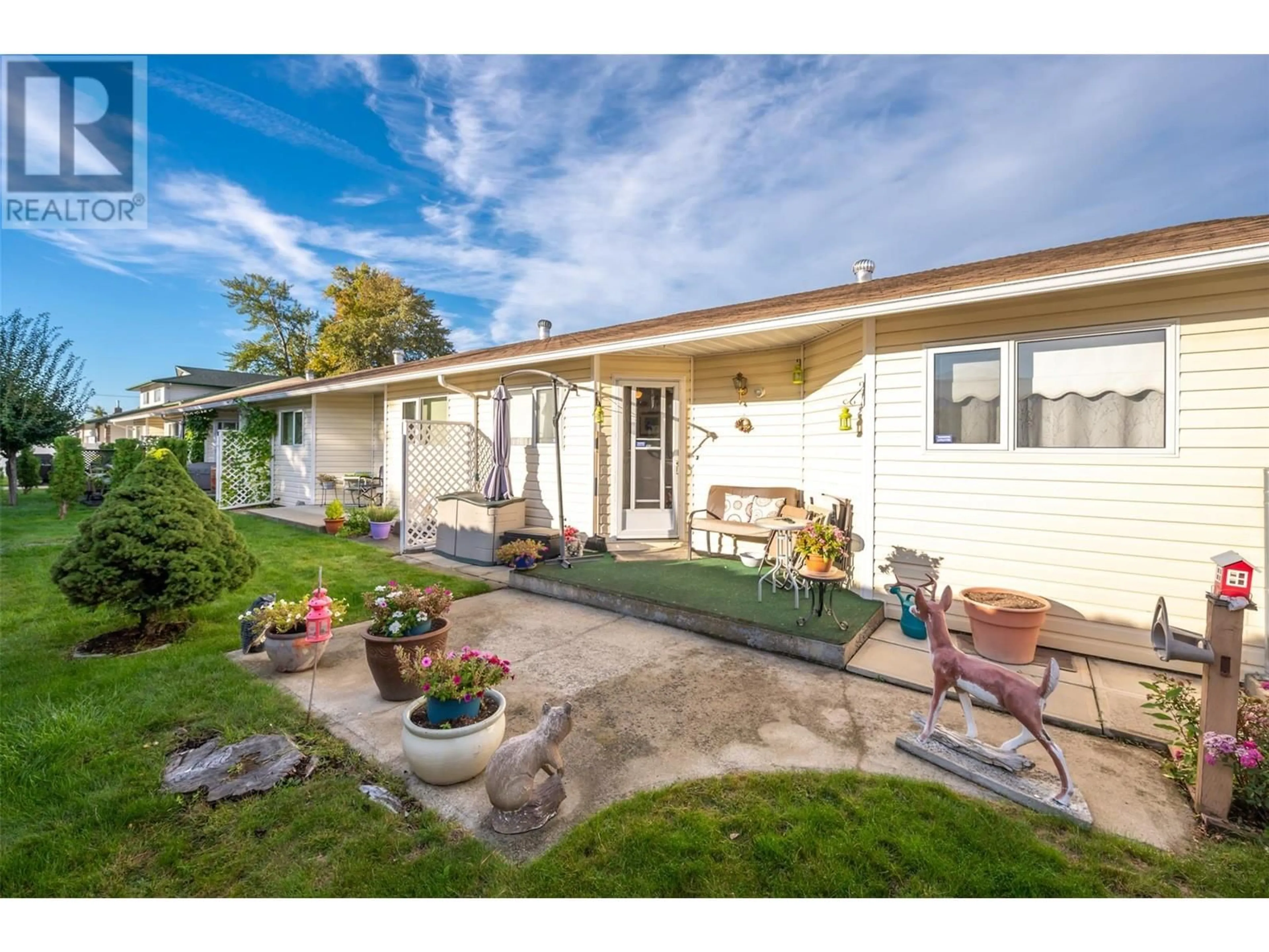 Frontside or backside of a home, the fenced backyard for 2235 Baskin Street Unit# 101, Penticton British Columbia V2A8A8