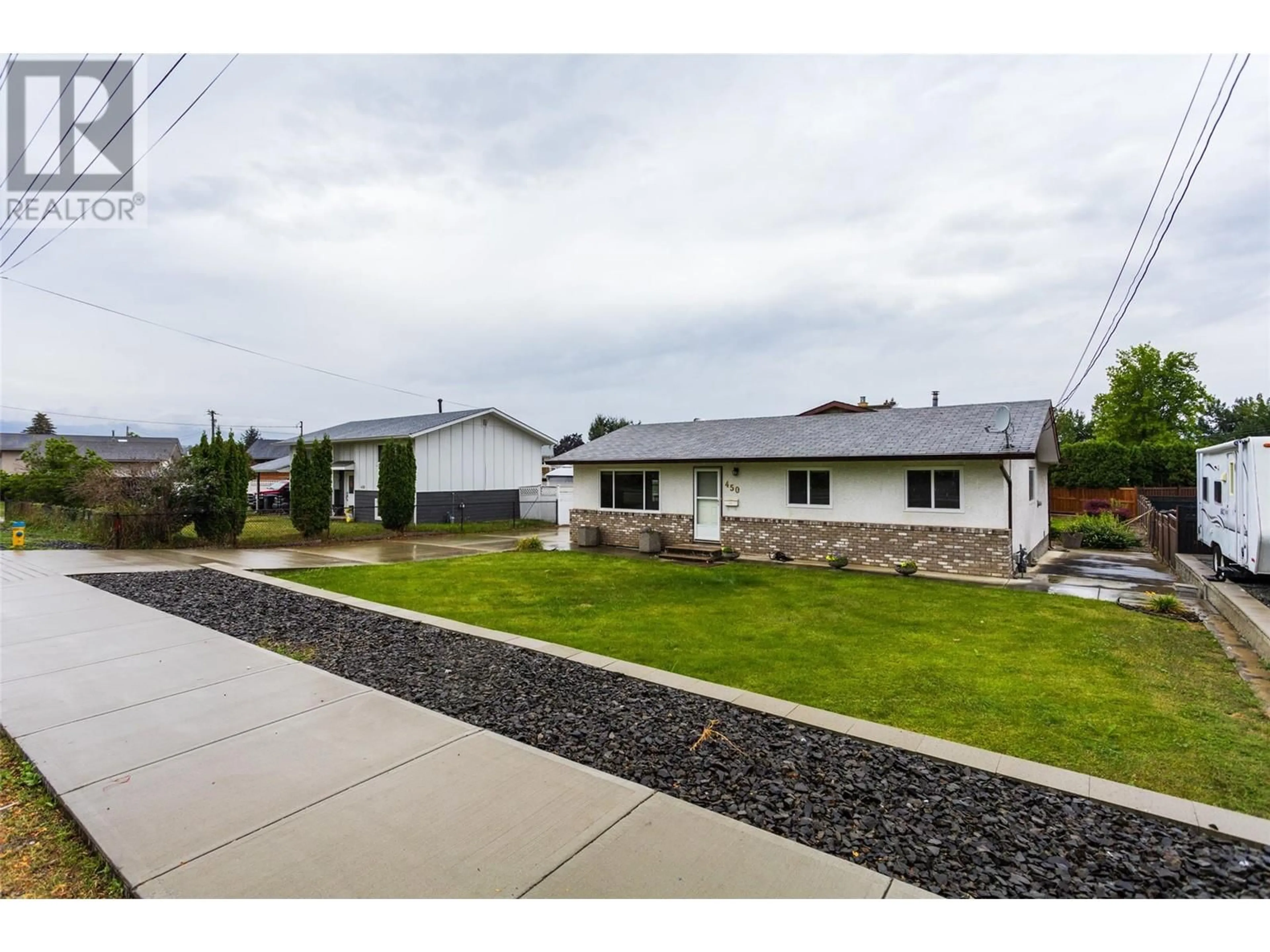 Frontside or backside of a home, the fenced backyard for 450 Hollywood Road S, Kelowna British Columbia V1X3T1