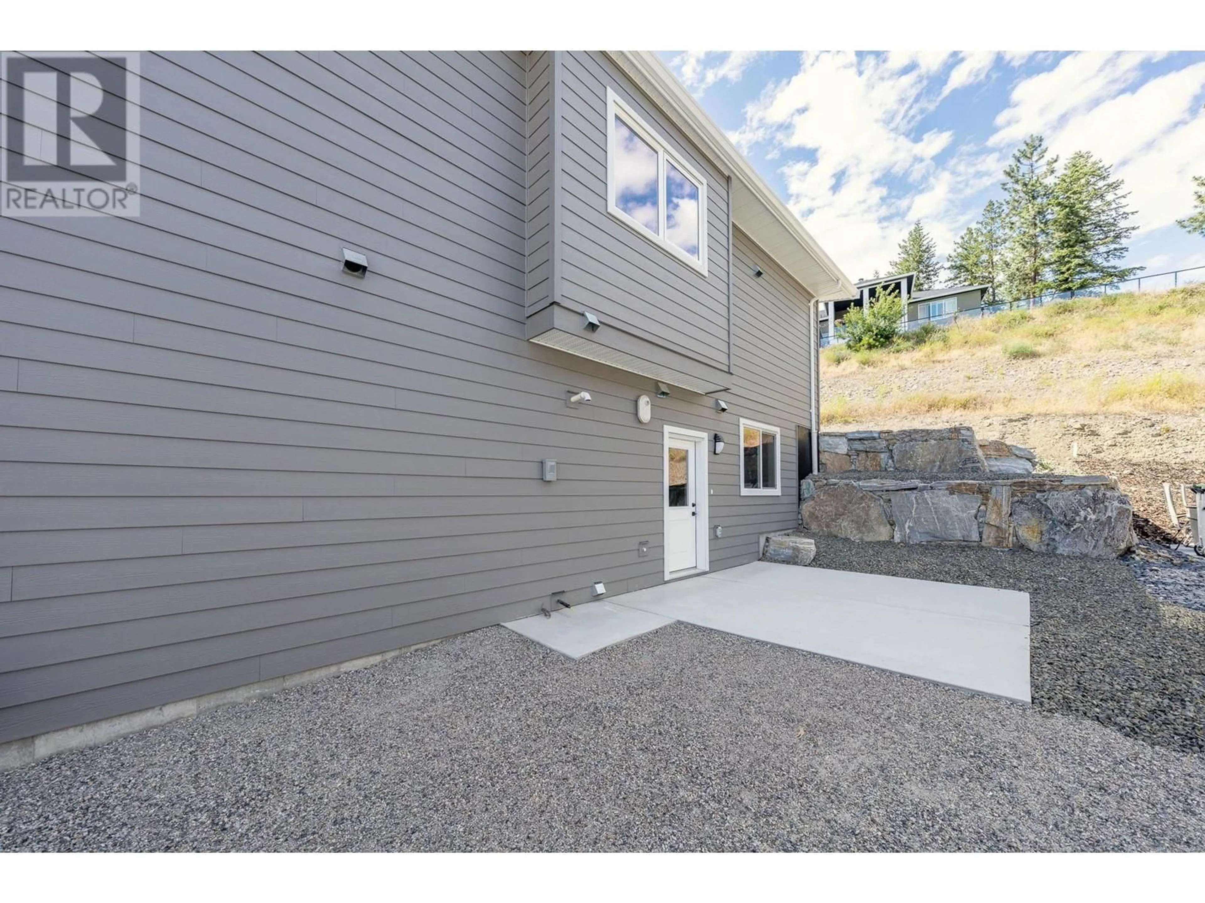 A pic from exterior of the house or condo, the fenced backyard for 2852 Canyon Crest Drive, West Kelowna British Columbia V4T3A6