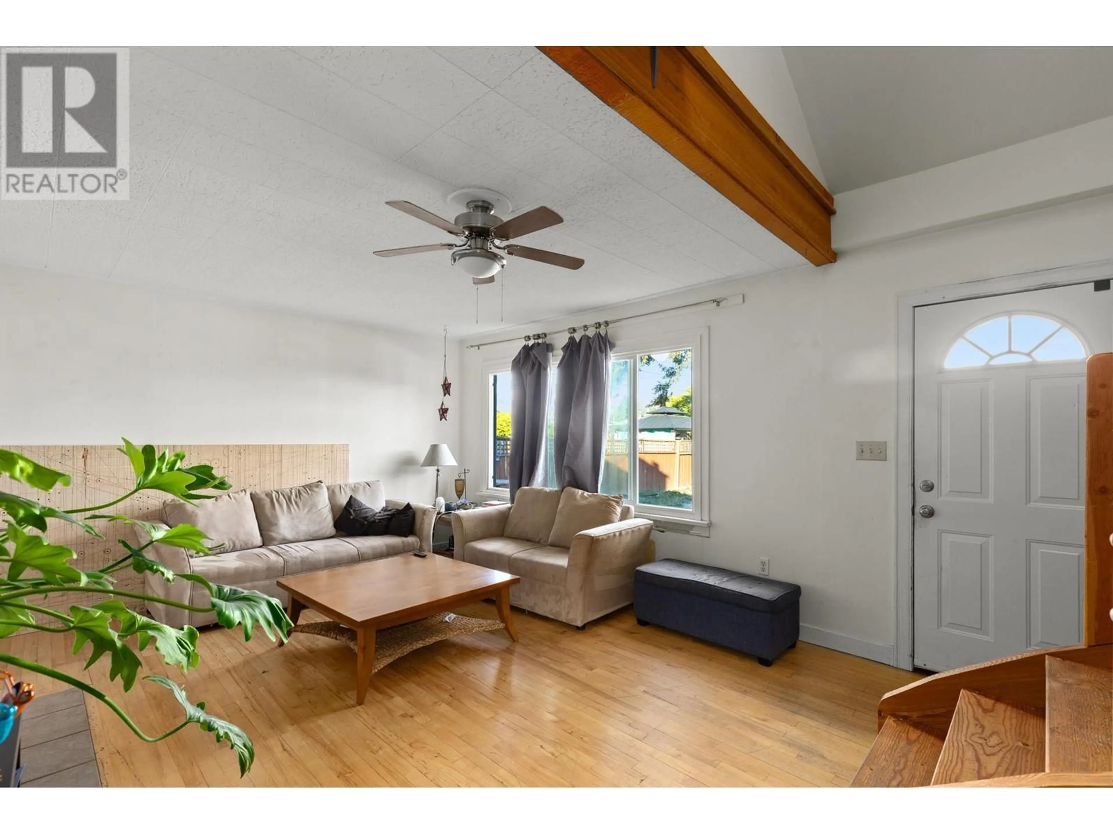 Living room with furniture, wood/laminate floor for 1762 GAGNON PLACE, Kelowna British Columbia V1Y3B4