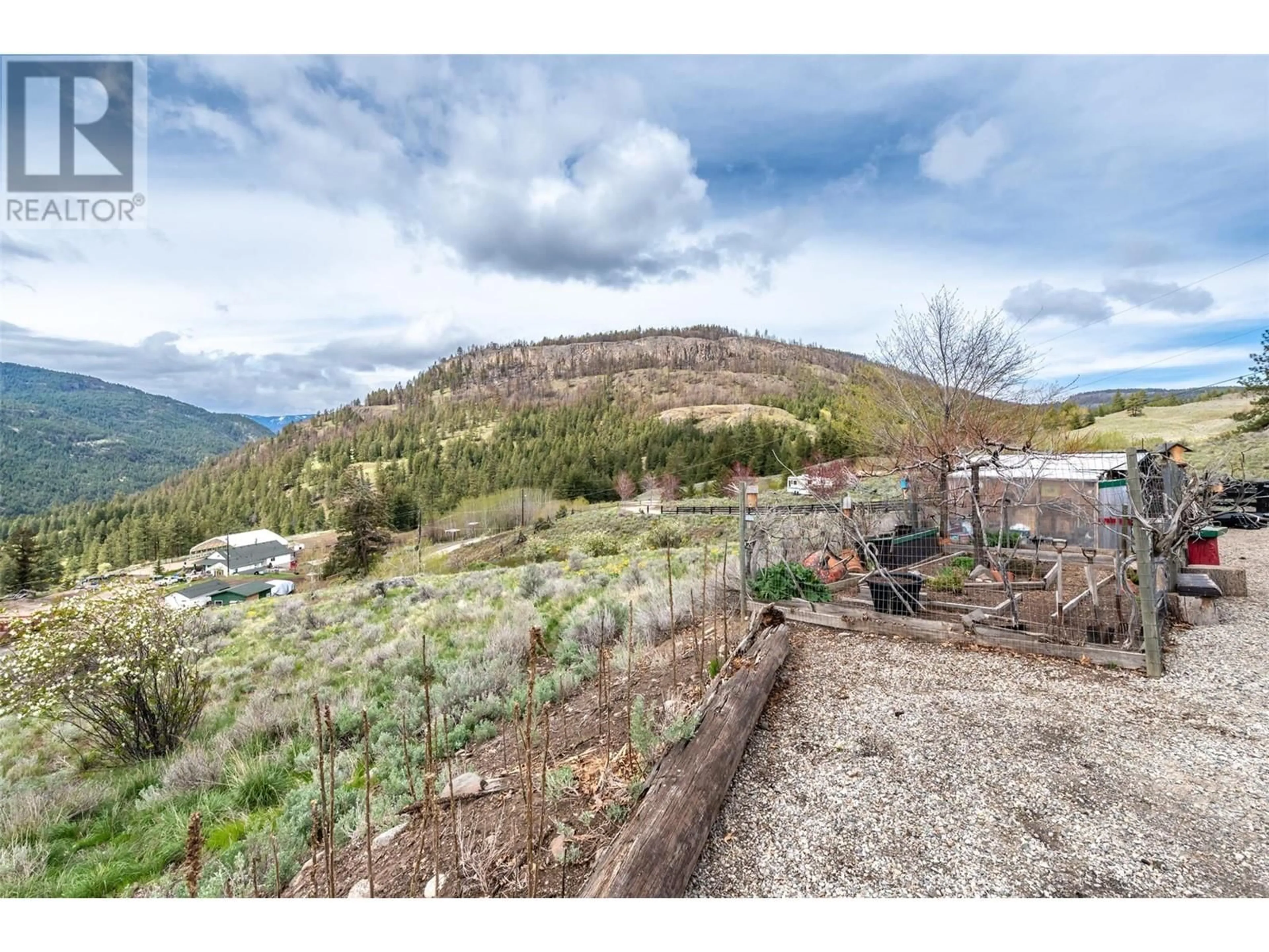 A pic from exterior of the house or condo, the fenced backyard for 795 Sheep Creek Road, Keremeos British Columbia V0K1K0