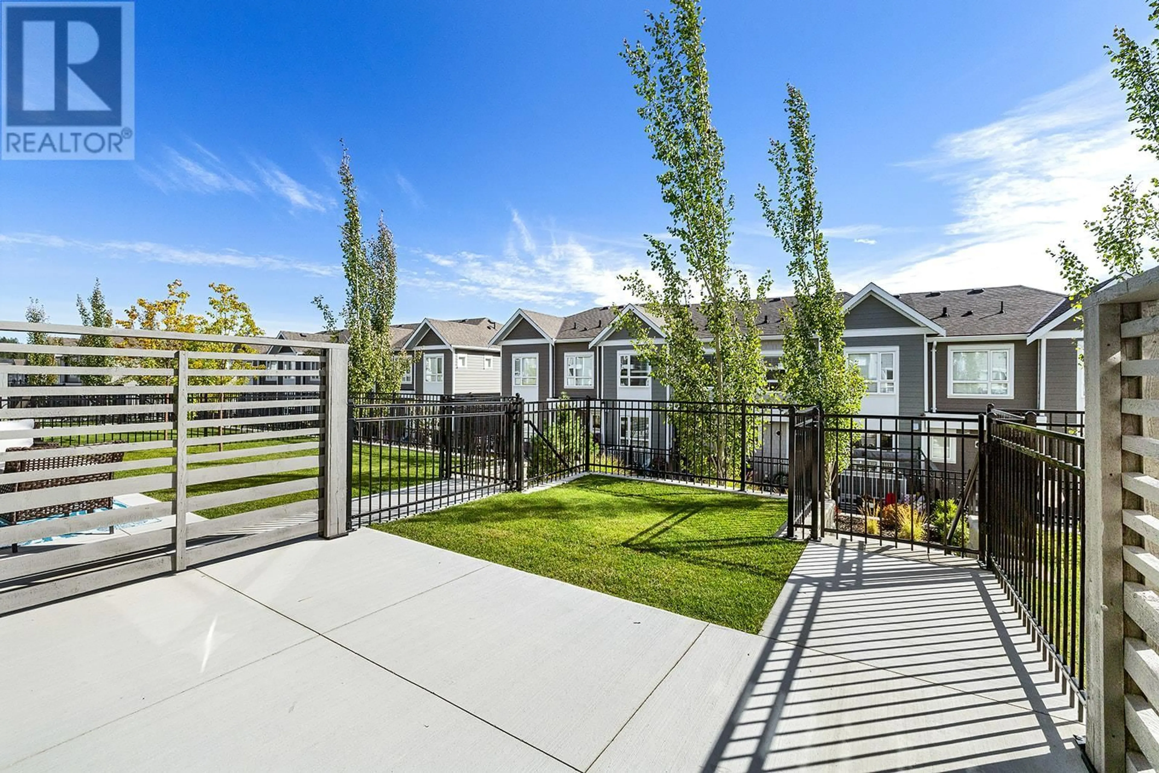 A pic from exterior of the house or condo, the fenced backyard for 13098 Shoreline Way Unit# 79, Lake Country British Columbia V4A0A8