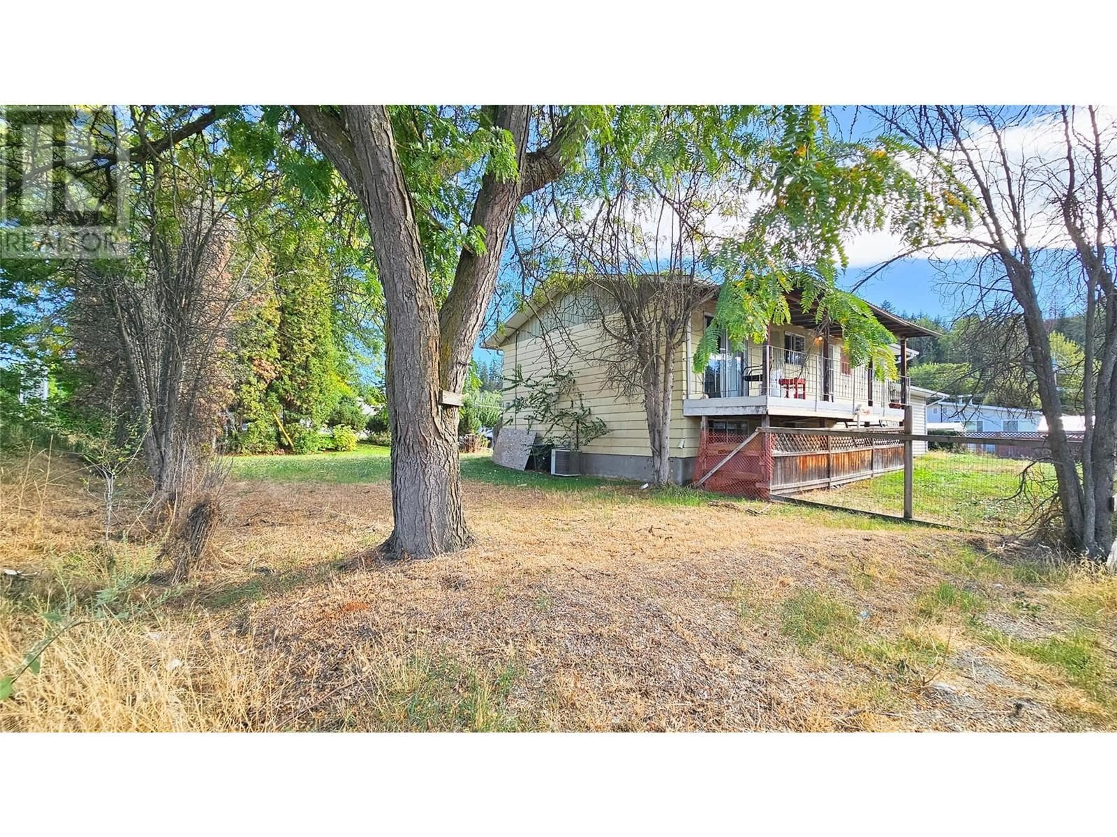 Frontside or backside of a home, the fenced backyard for 850 Kiniski Road, Kelowna British Columbia V1Y4Z9