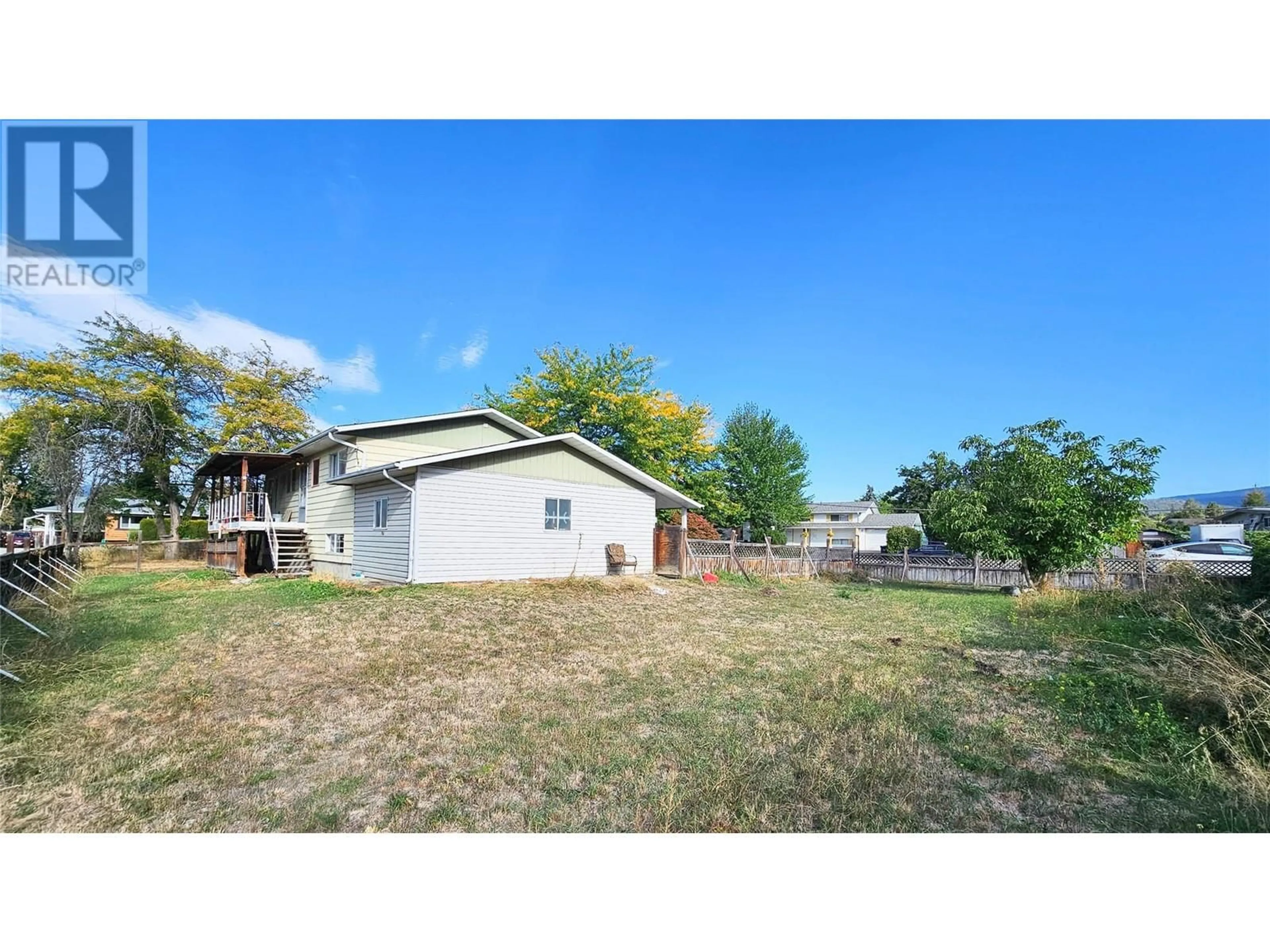 Frontside or backside of a home, the fenced backyard for 850 Kiniski Road, Kelowna British Columbia V1Y4Z9