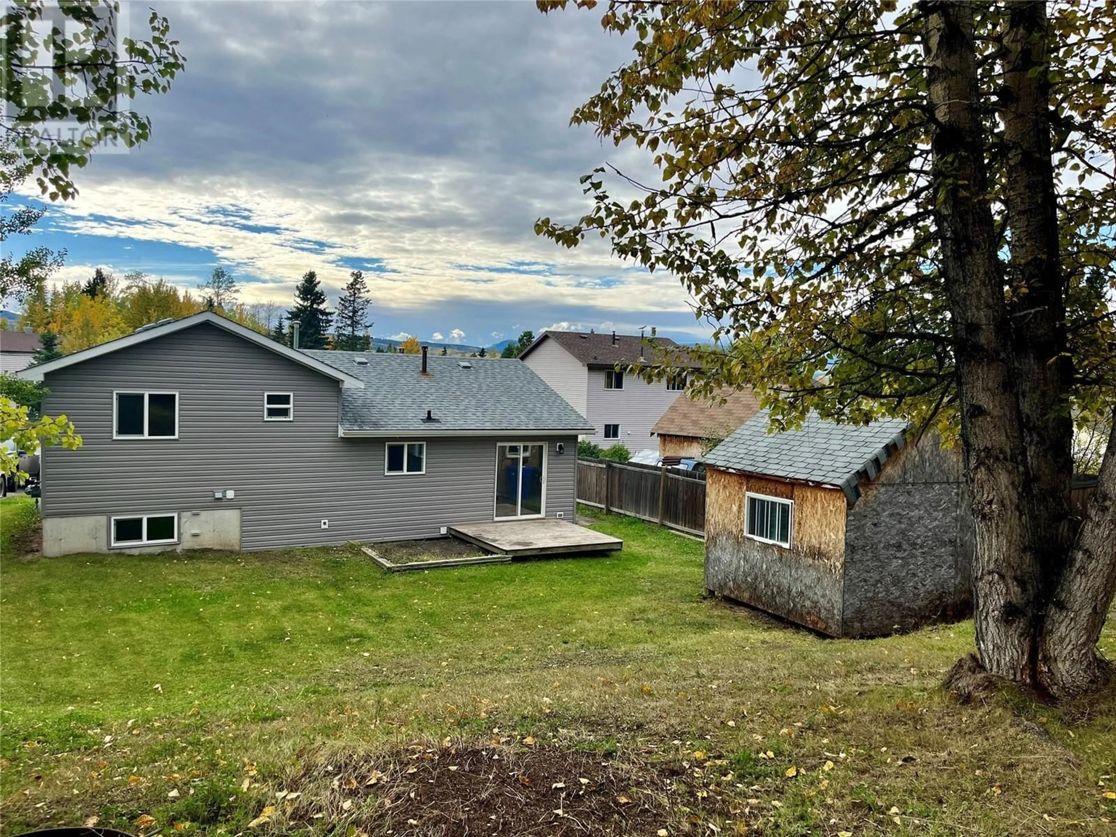 Frontside or backside of a home, the fenced backyard for 44 Sukunka Place, Tumbler Ridge British Columbia V0C2W0