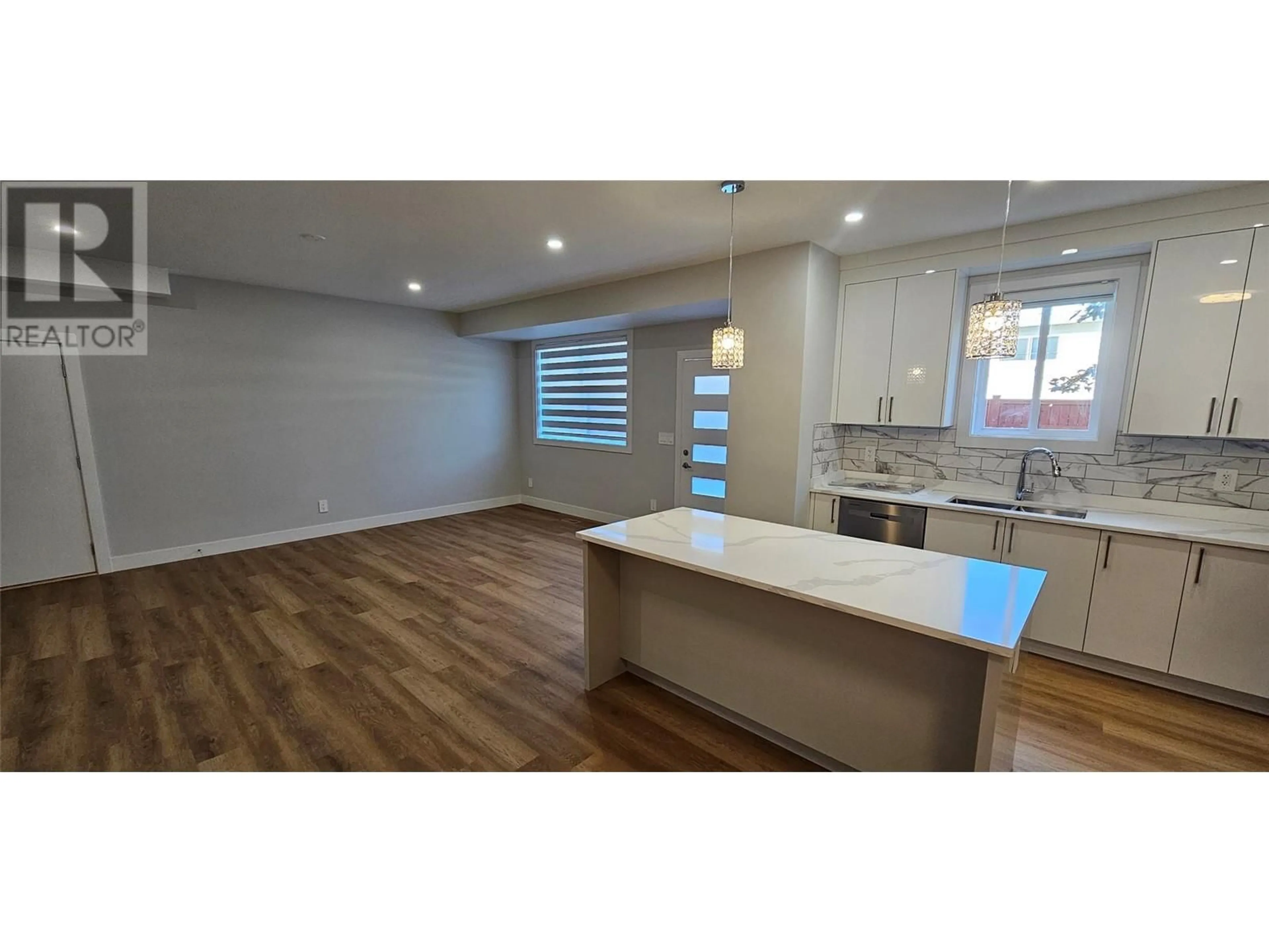 Open concept kitchen, wood/laminate floor for 104 125 CALGARY AVENUE, Penticton British Columbia V2A2T7