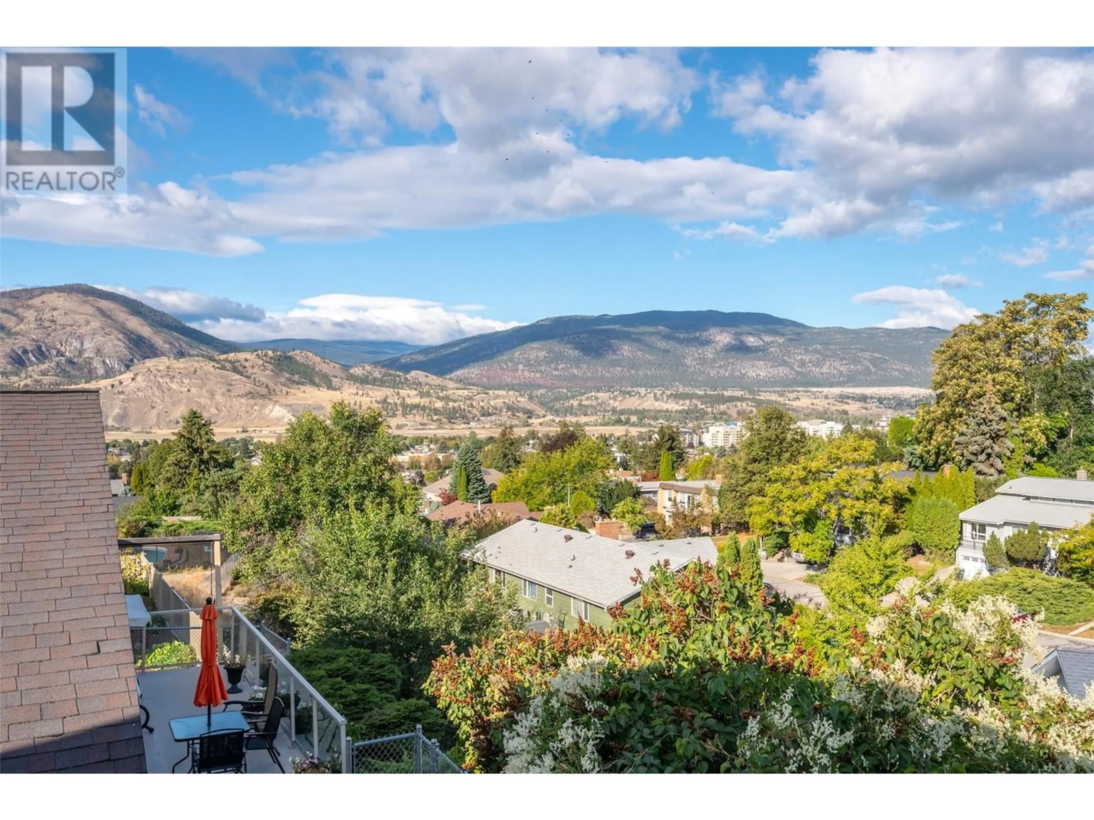 A pic from exterior of the house or condo, the fenced backyard for 217 GREENWOOD Drive, Penticton British Columbia V2A7P9