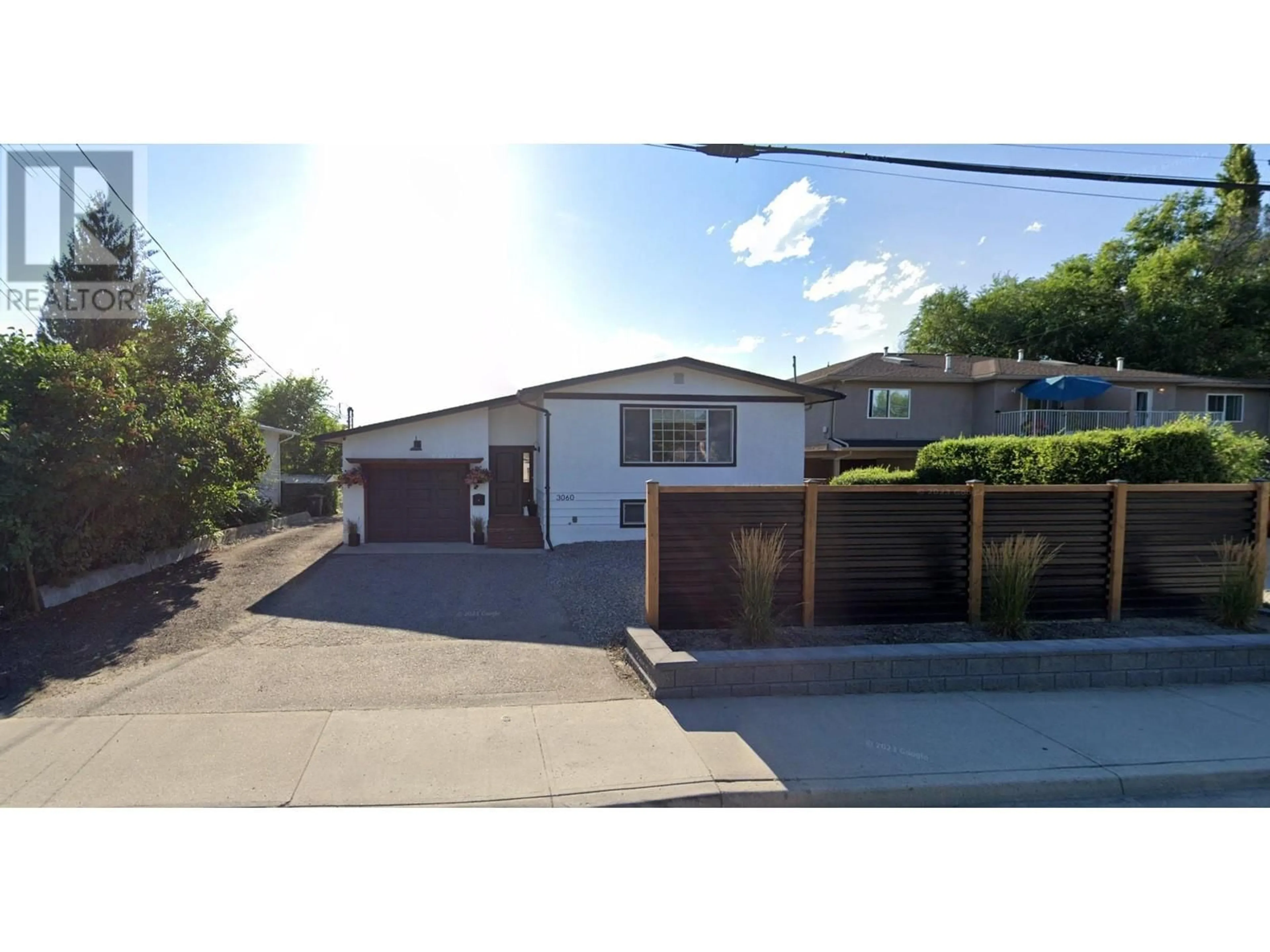 Frontside or backside of a home, the street view for 3060 Gordon Drive, Kelowna British Columbia V1W3R3