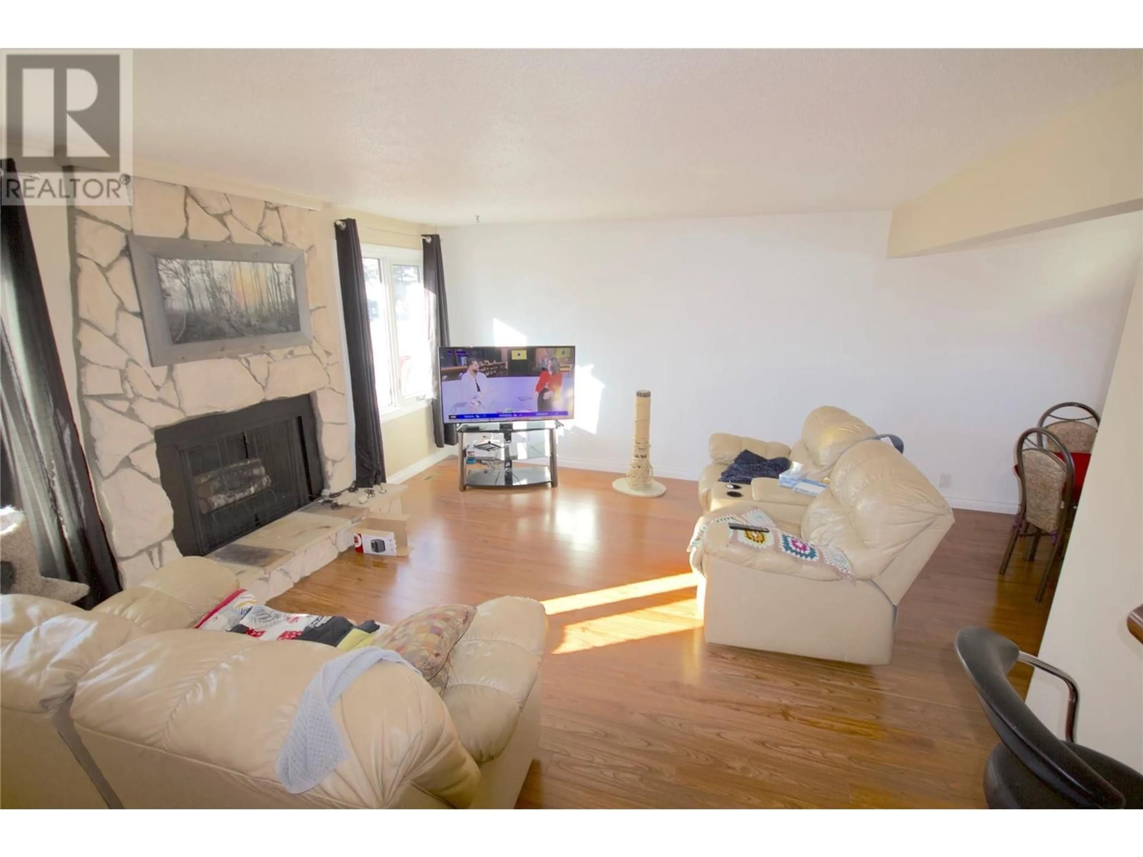 Living room with furniture, wood/laminate floor for 1828 108 AVENUE, Dawson Creek British Columbia V1G2T8