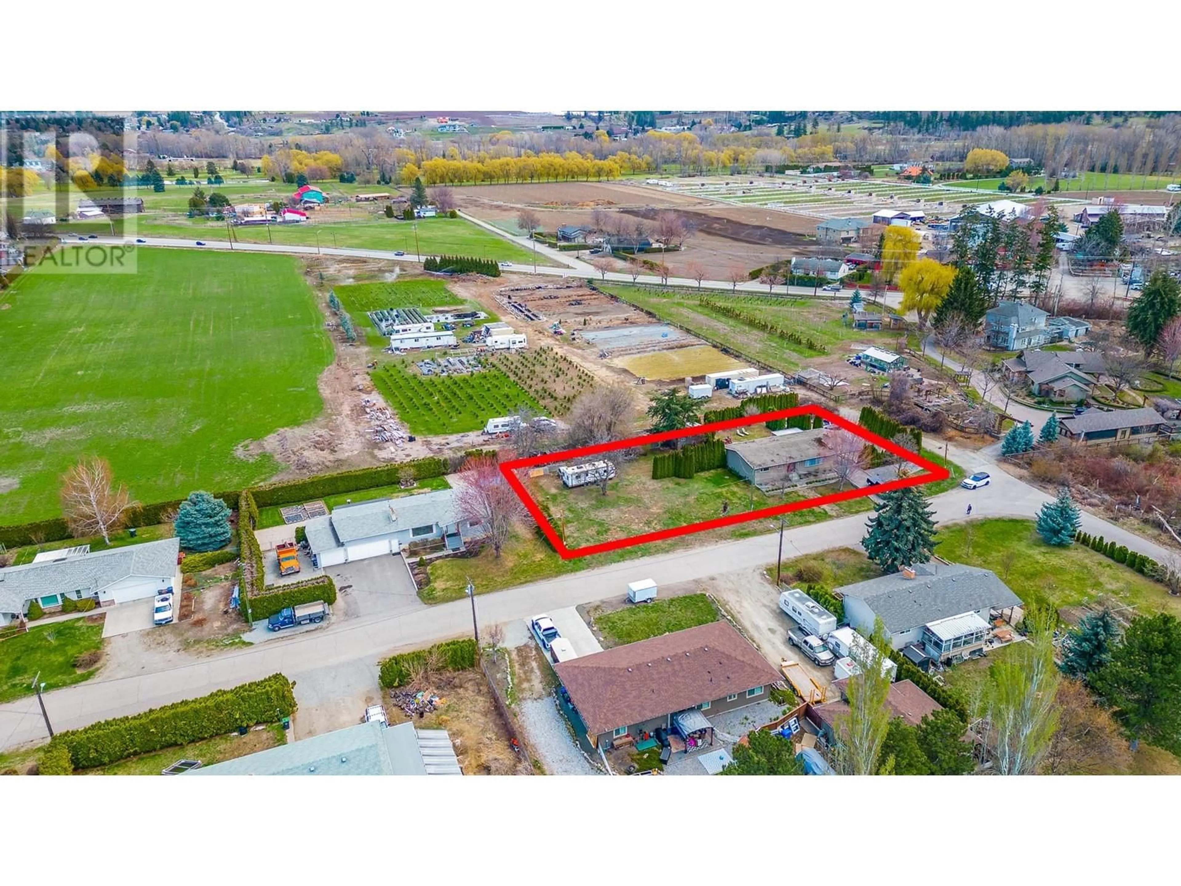 Frontside or backside of a home, the fenced backyard for 3259 St. Amand Road, Kelowna British Columbia V1W3P2