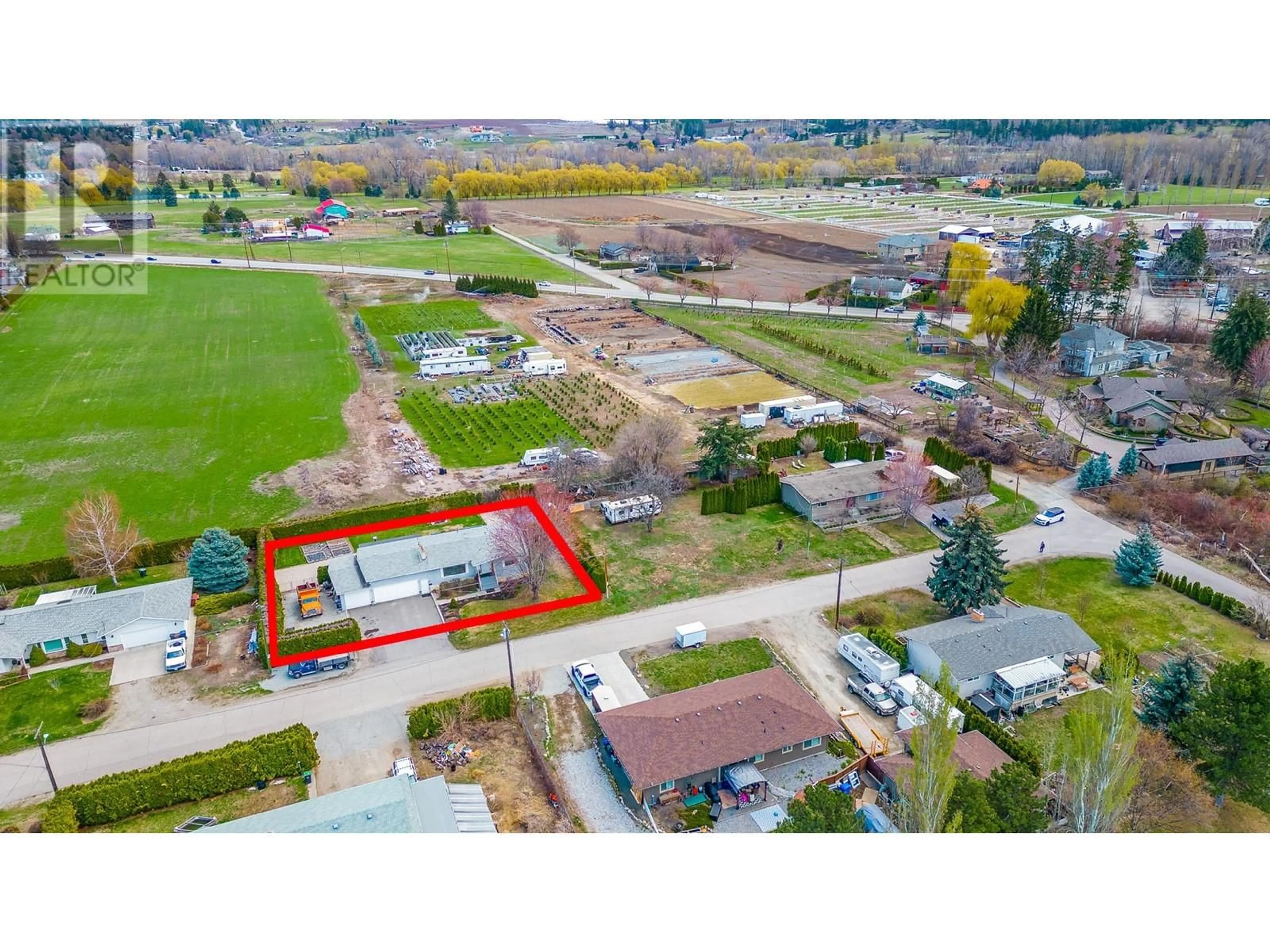 Frontside or backside of a home, the fenced backyard for 3249 St. Amand Road, Kelowna British Columbia V1W3P2