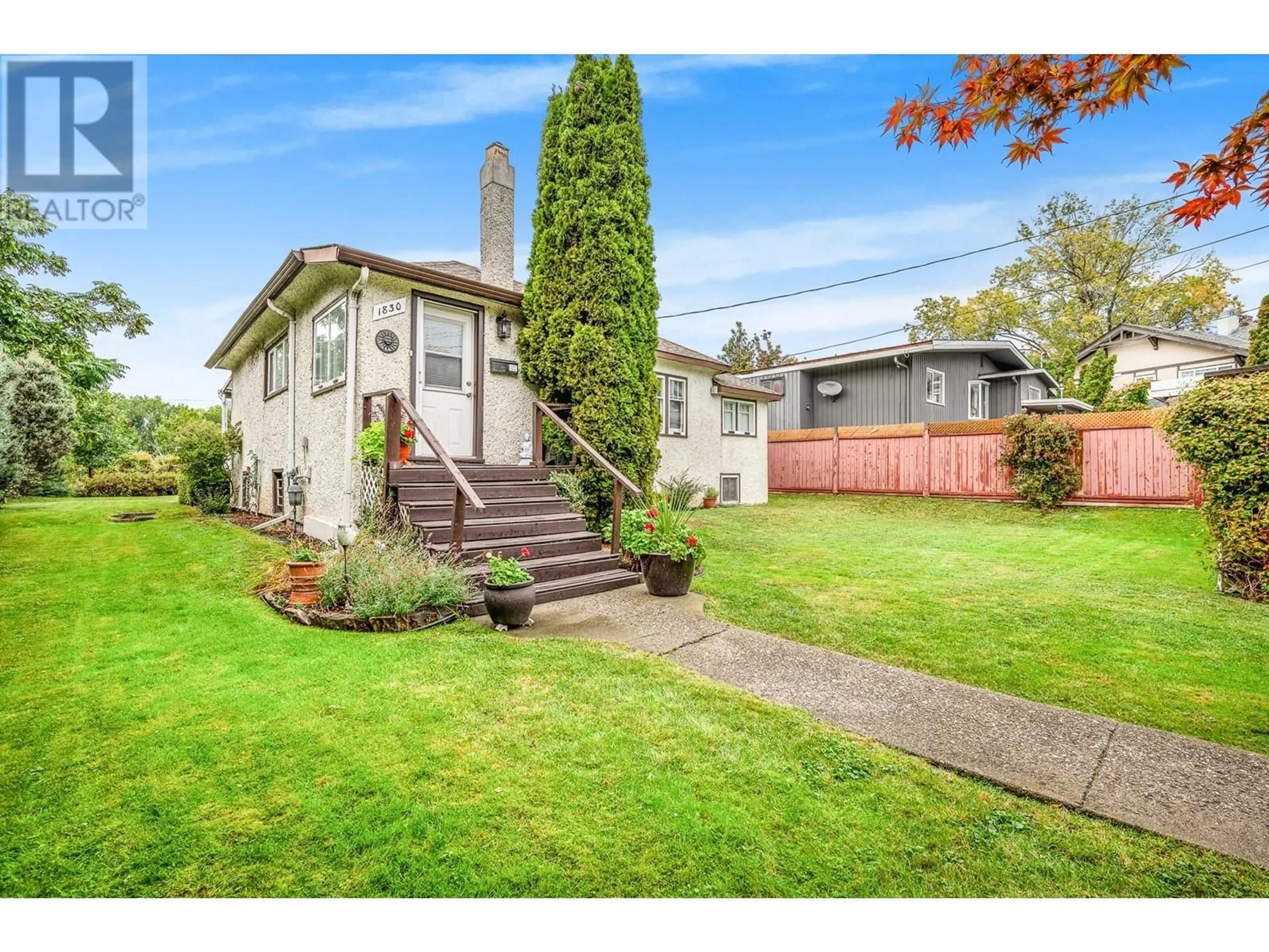 Frontside or backside of a home, the fenced backyard for 1830 Riverside Avenue, Kelowna British Columbia V1Y1A7