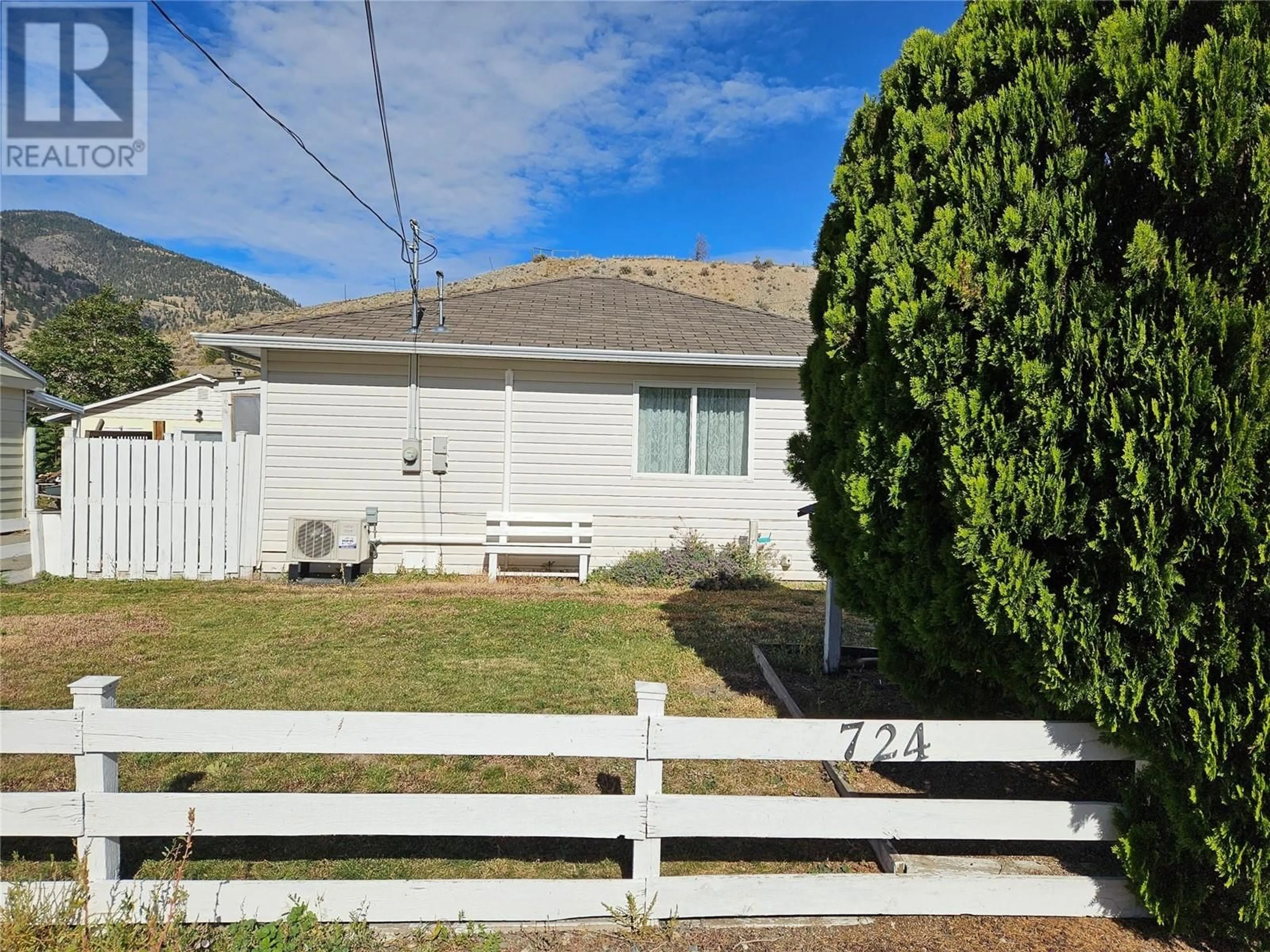 Frontside or backside of a home, the fenced backyard for 724 6th Avenue, Keremeos British Columbia V0X1N3