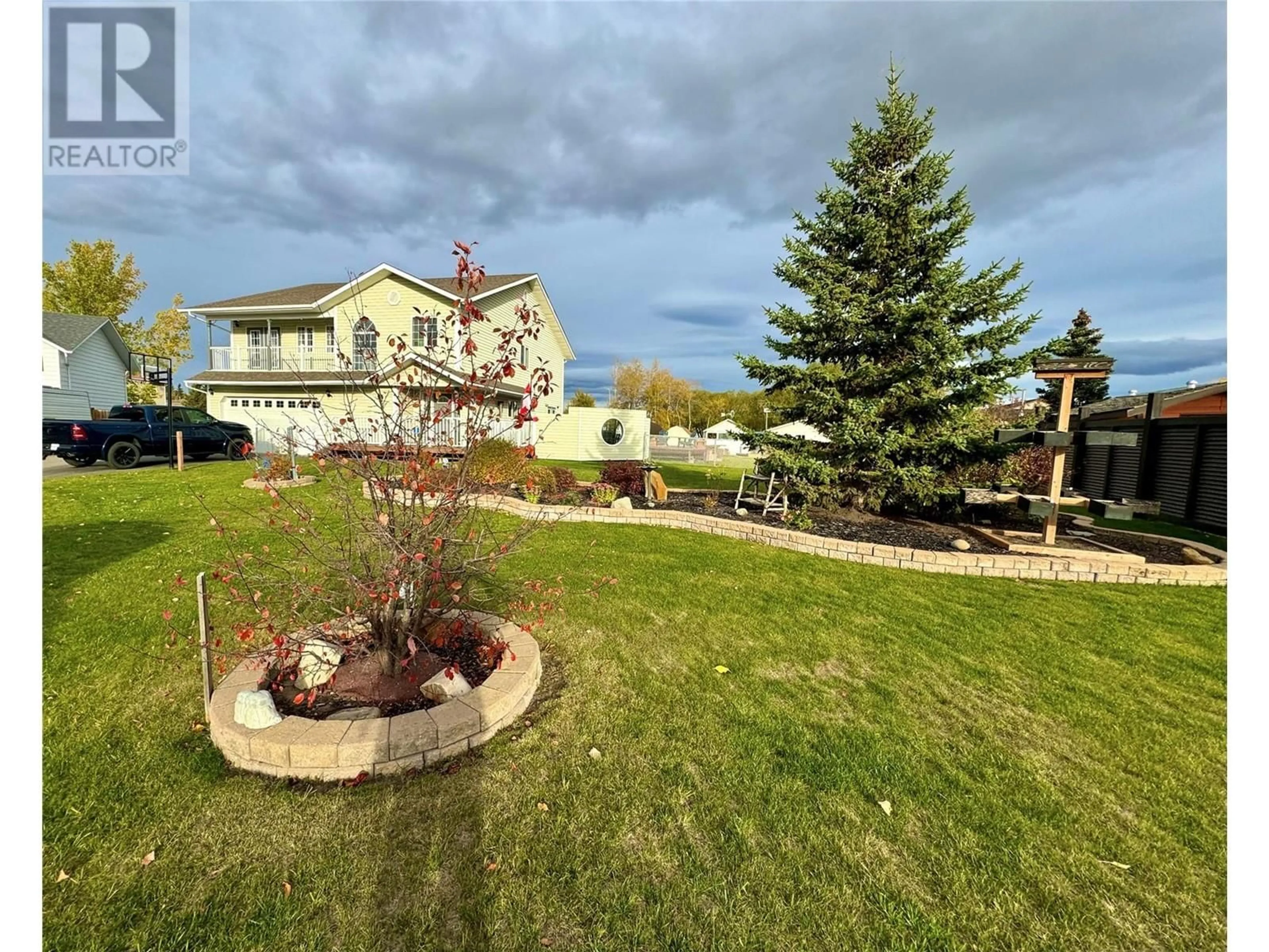 A pic from exterior of the house or condo, the fenced backyard for 10681 Cottonwood Cresent, Dawson Creek British Columbia V1G4M3