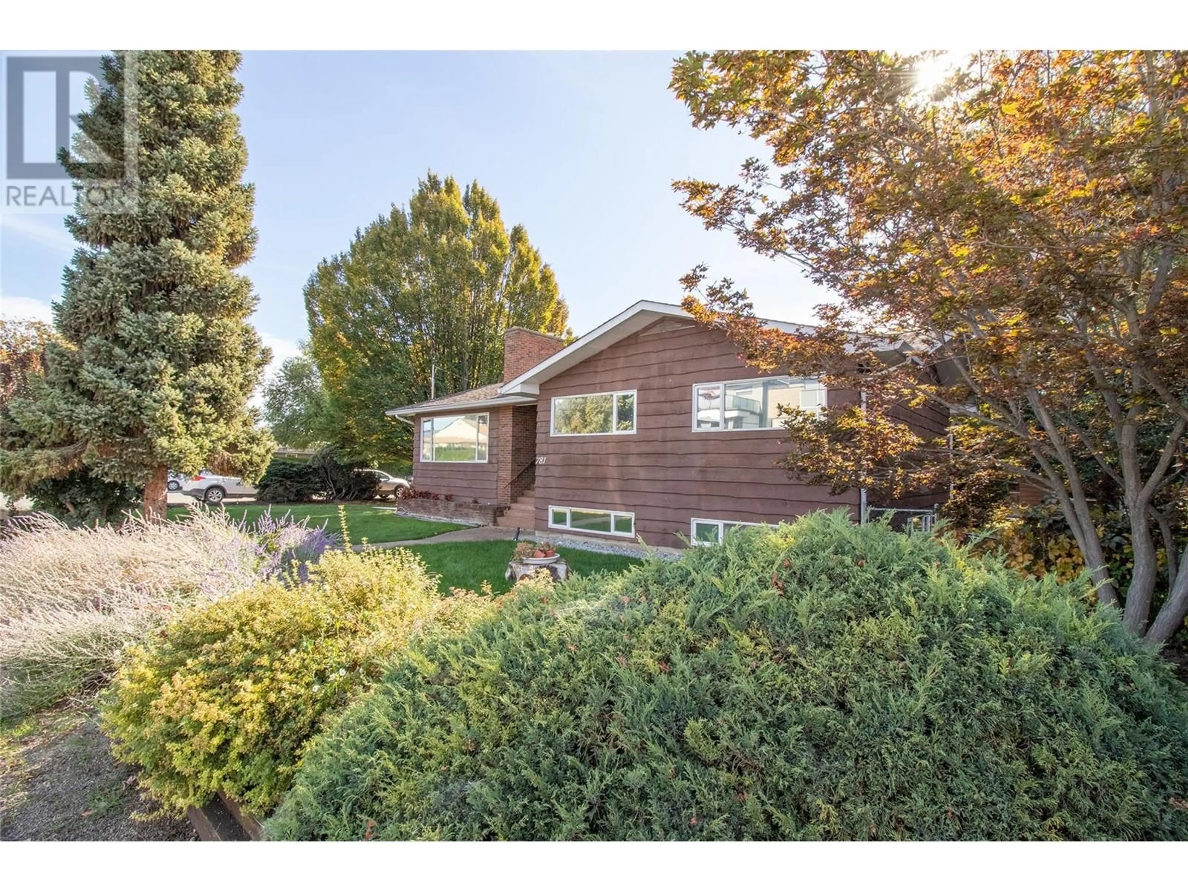 Frontside or backside of a home, the fenced backyard for 781 Wardlaw Avenue, Kelowna British Columbia V1Y5B8