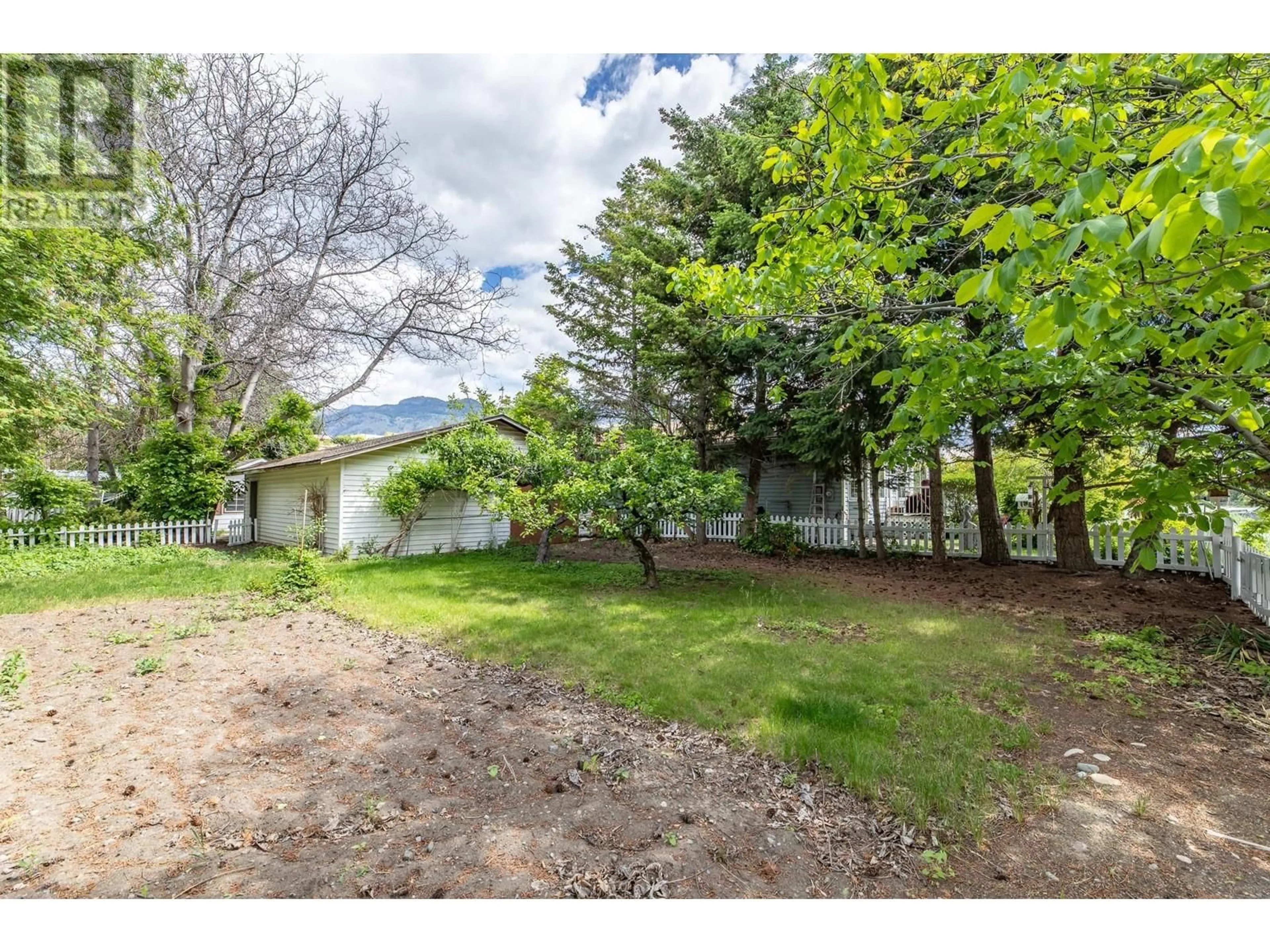 Frontside or backside of a home, the fenced backyard for 406 6TH Avenue, Keremeos British Columbia V0X1N3