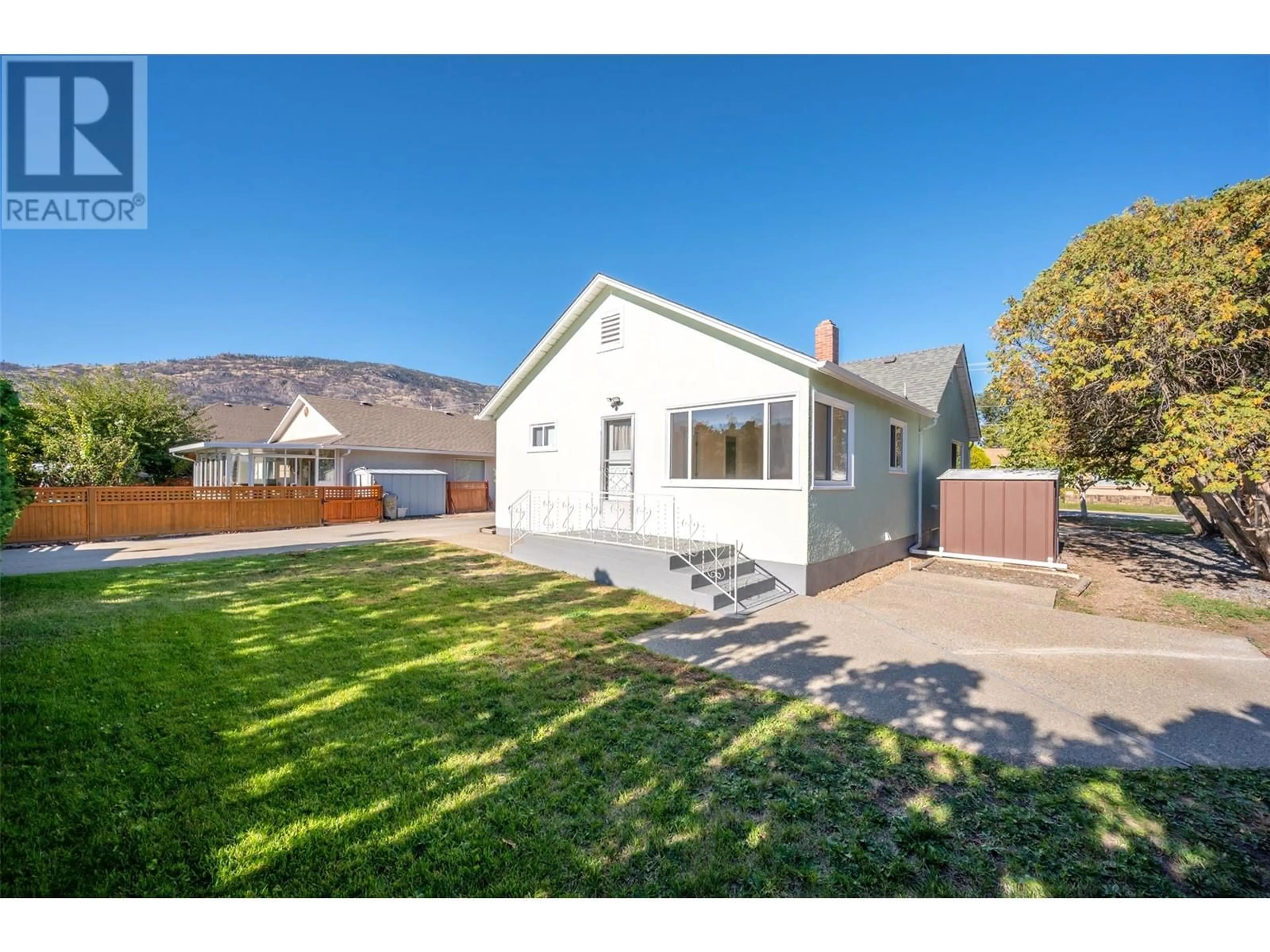 Frontside or backside of a home, the fenced backyard for 9105 74 Avenue, Osoyoos British Columbia V0H1V5