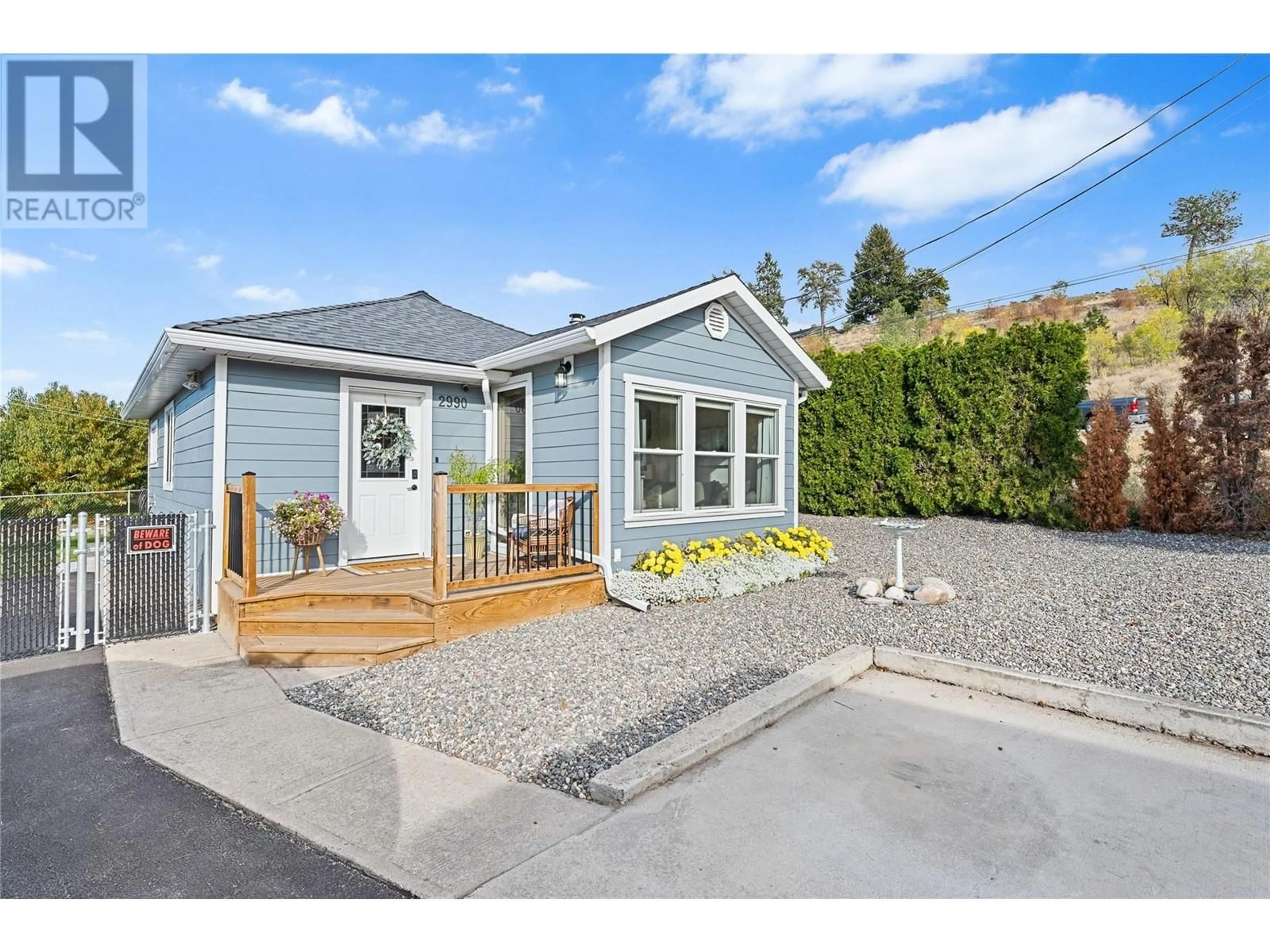 Frontside or backside of a home, the fenced backyard for 2990 McCulloch Road, Kelowna British Columbia V1W4A5