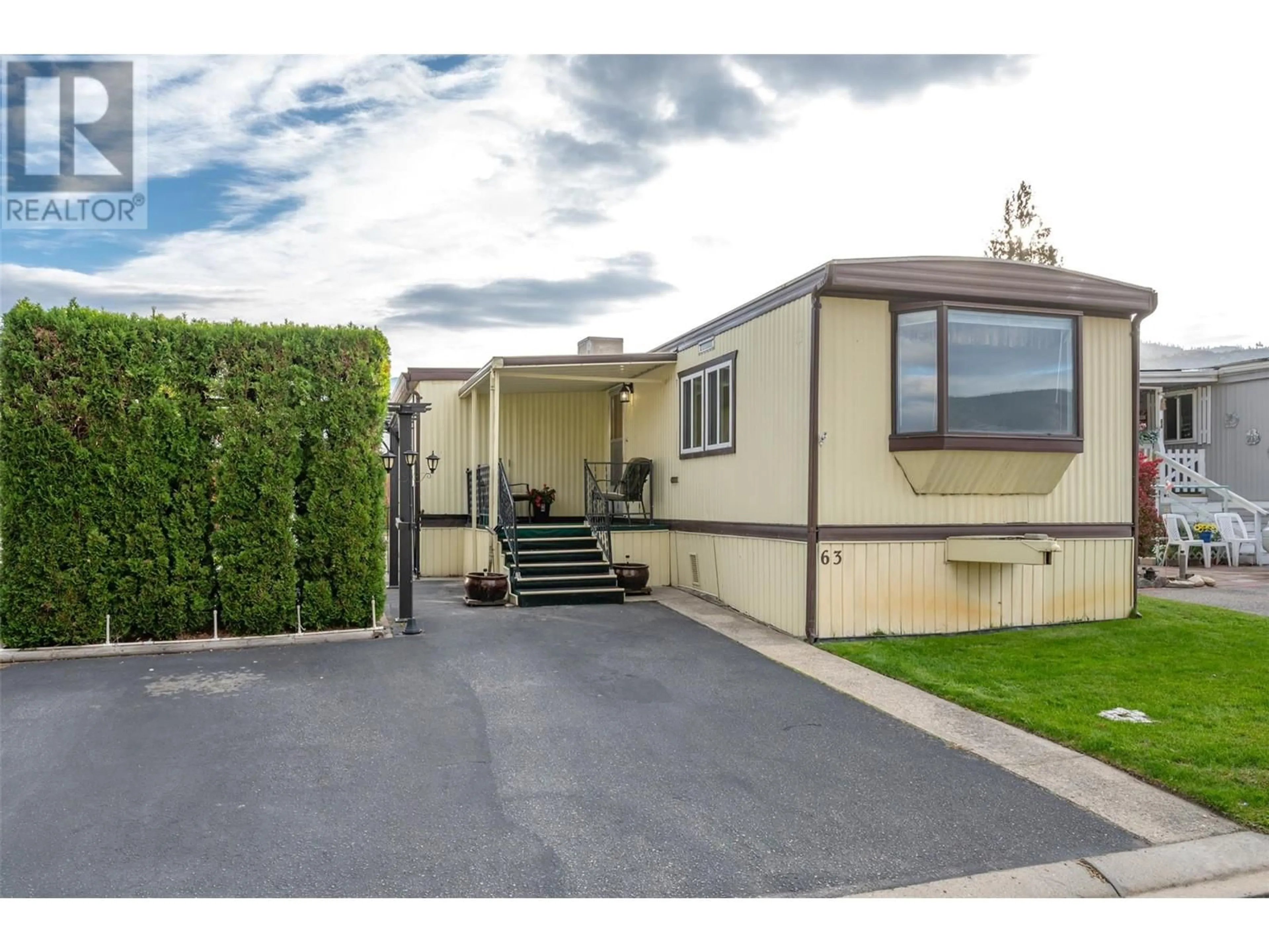 A pic from exterior of the house or condo, the fenced backyard for 98 Okanagan Avenue E Unit# 63, Penticton British Columbia V2A3J5