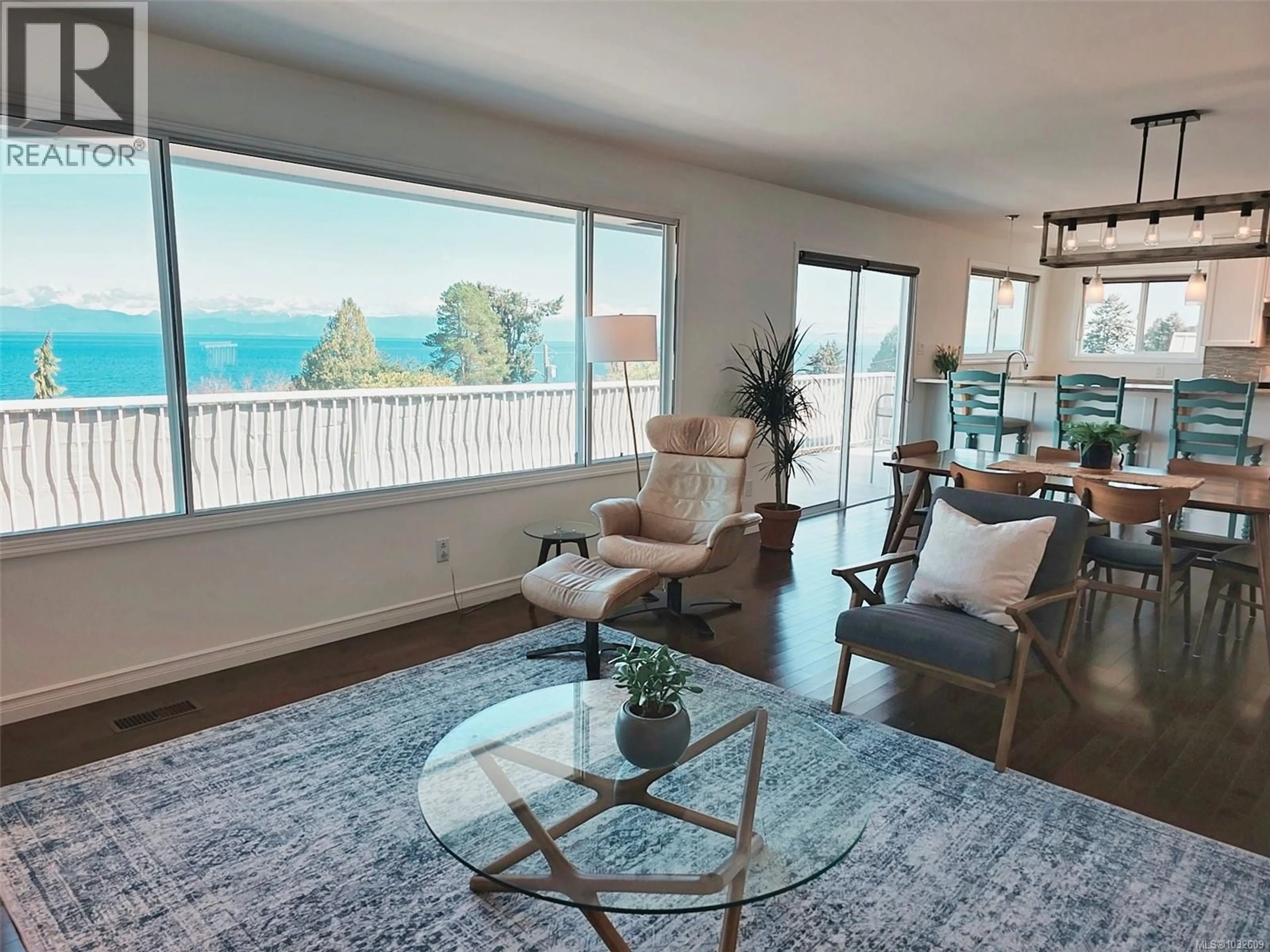 Living room with furniture, wood/laminate floor for 7158 DICKINSON ROAD, Lantzville British Columbia V0R2H0