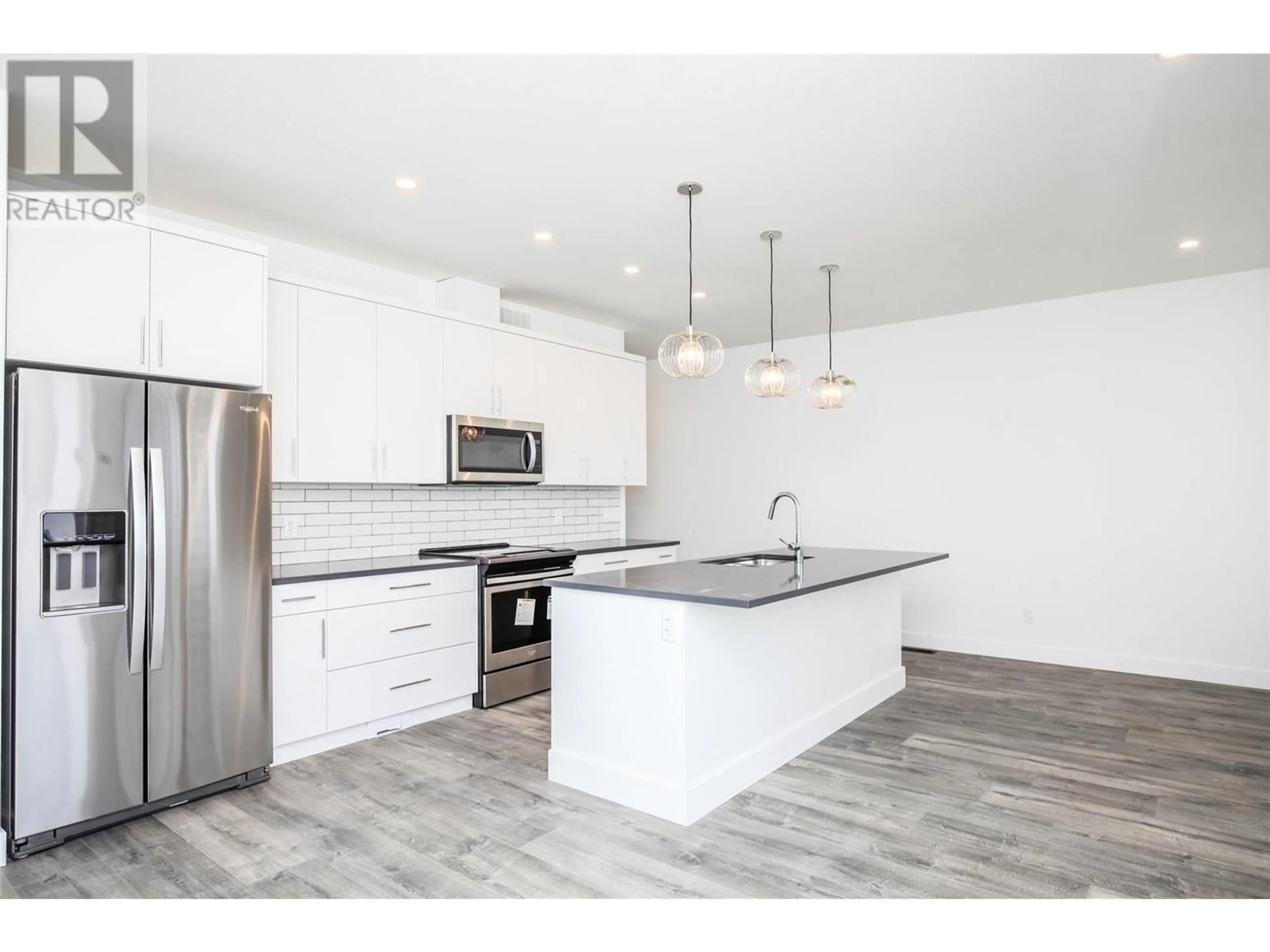 Open concept kitchen for 610 Academy Way Unit# 114, Kelowna British Columbia V1Y9T1