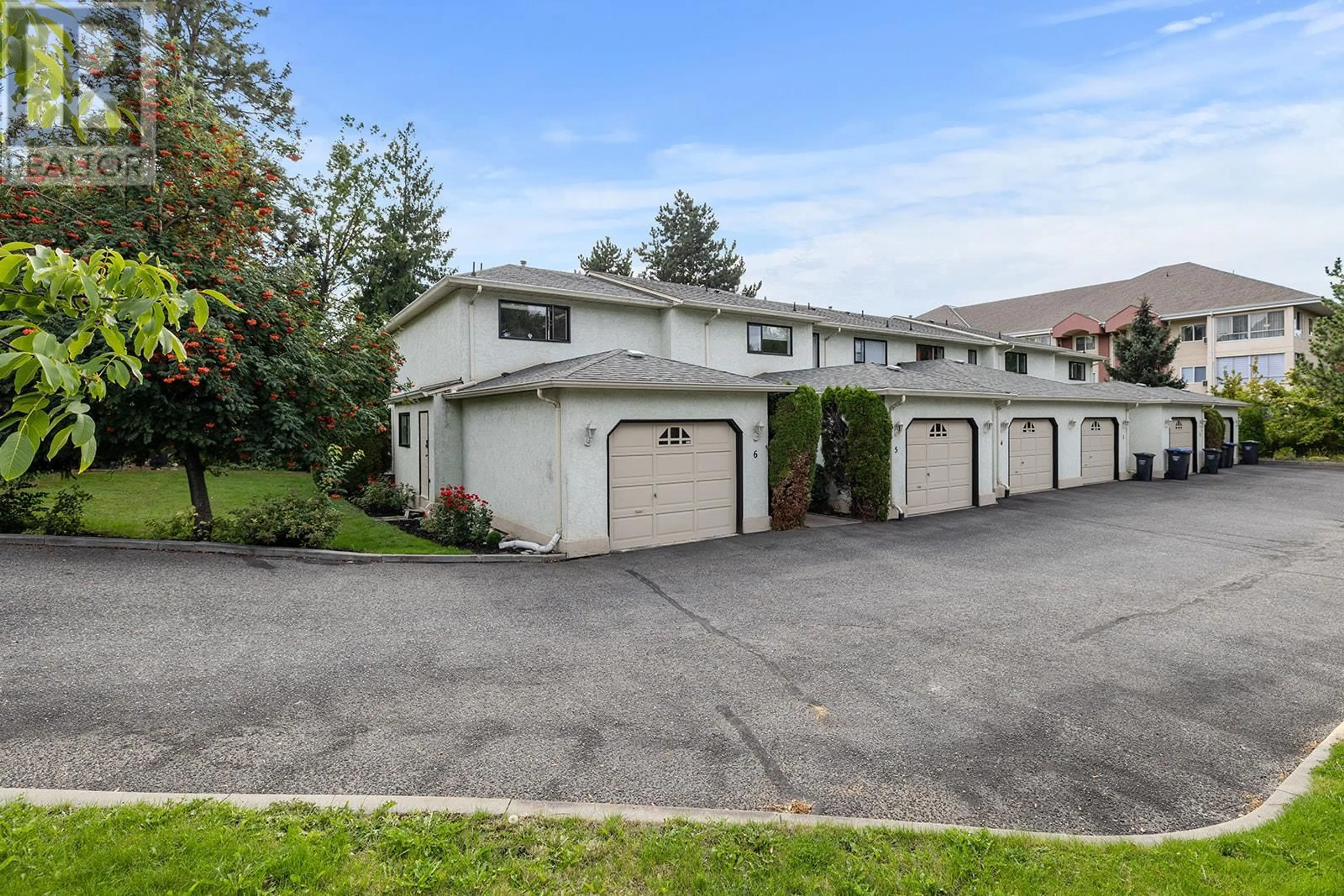 A pic from exterior of the house or condo, the fenced backyard for 130 Dundas Road Unit# 6, Kelowna British Columbia V1X7H2