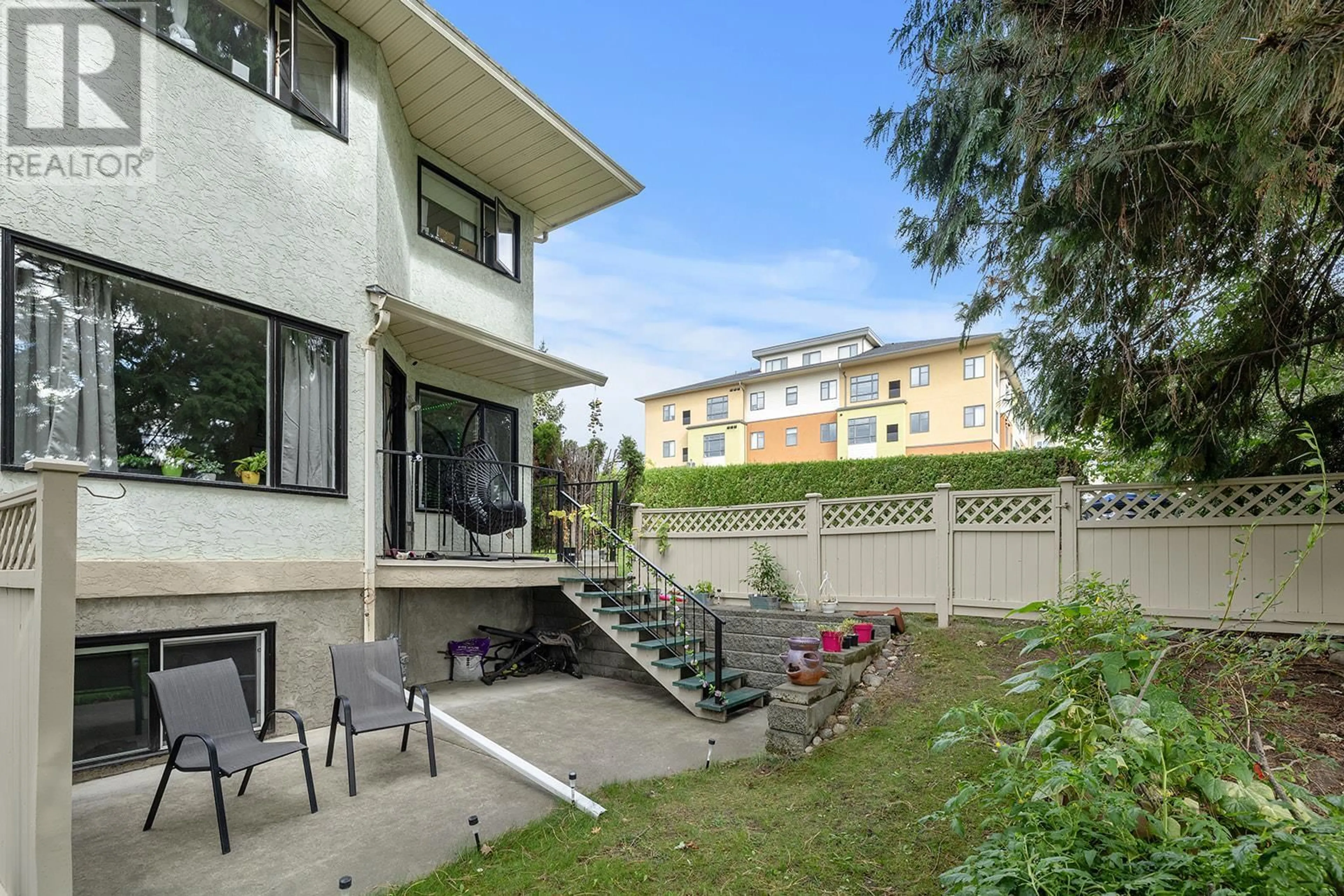 A pic from exterior of the house or condo, the fenced backyard for 130 Dundas Road Unit# 6, Kelowna British Columbia V1X7H2