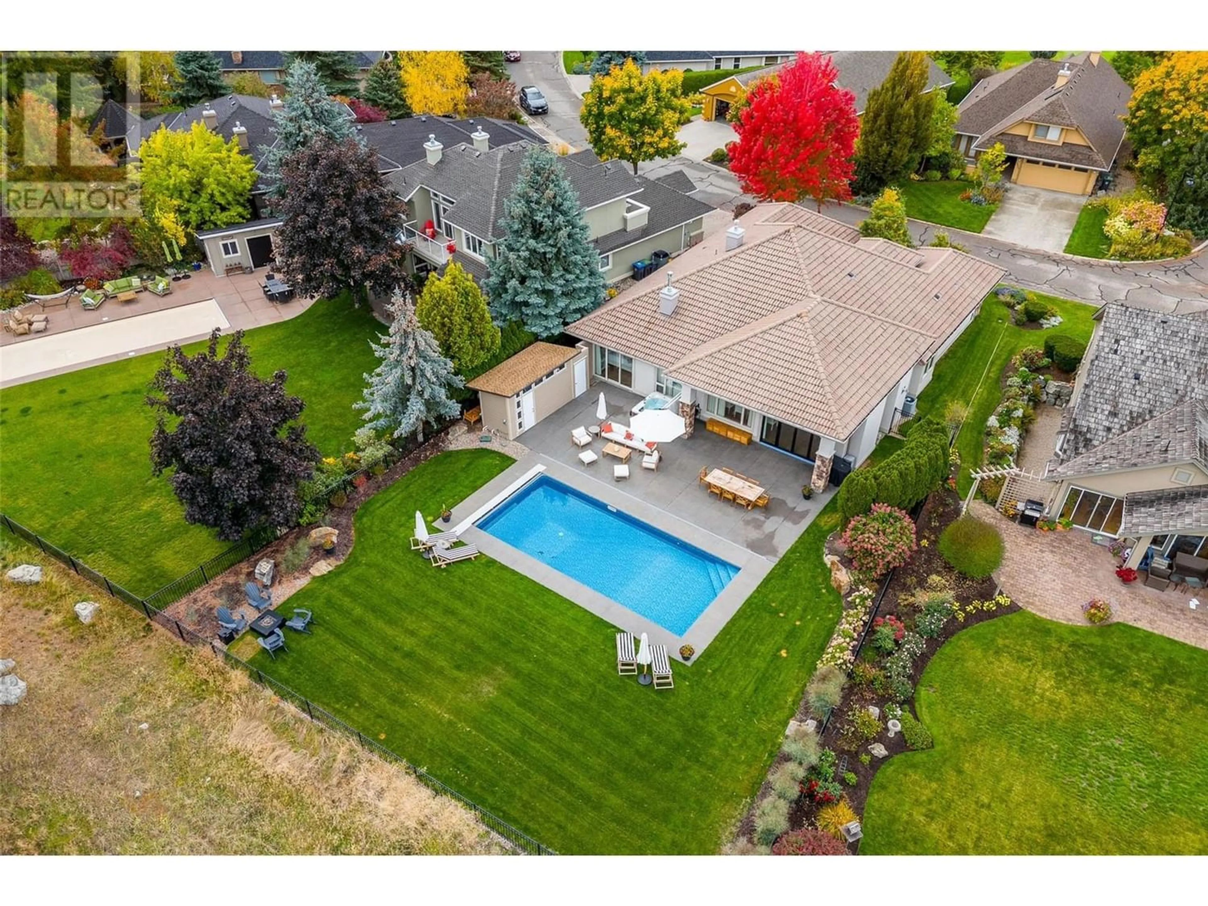 Frontside or backside of a home, the fenced backyard for 3813 Gallaghers Parkway, Kelowna British Columbia V1W3Z8