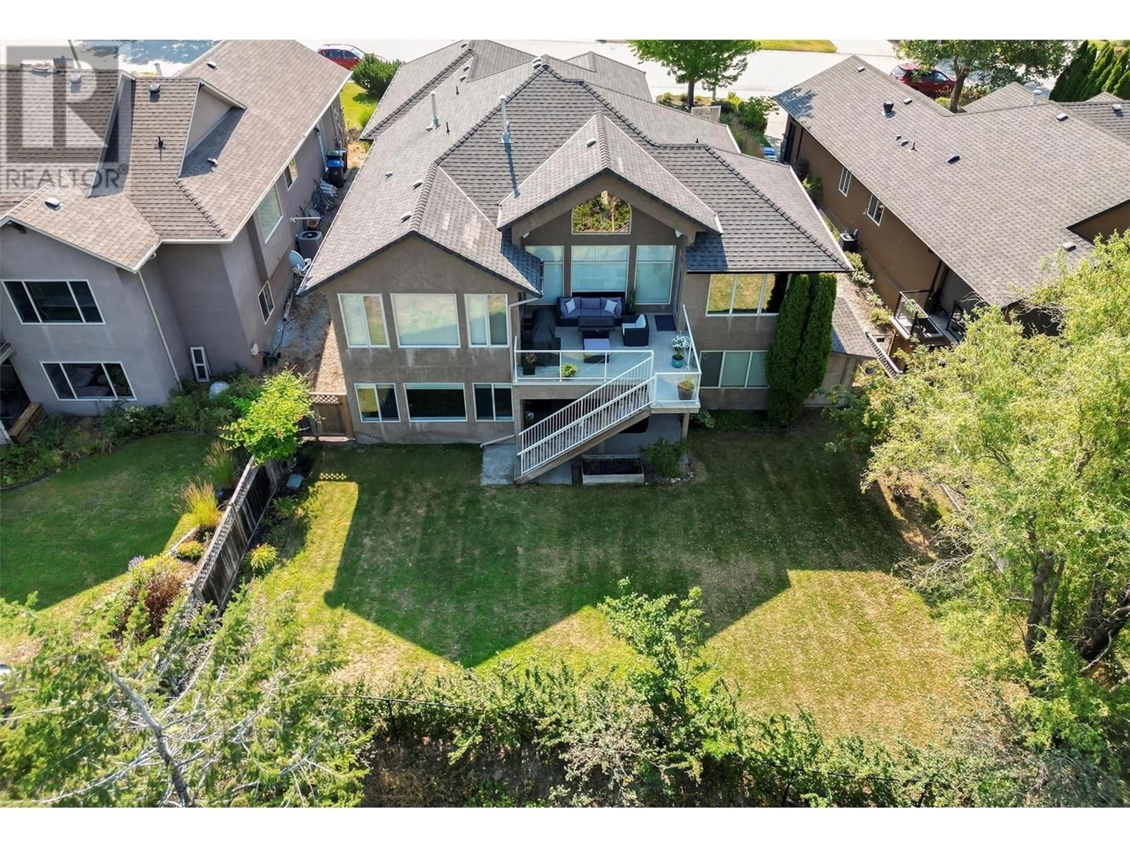 Frontside or backside of a home, the fenced backyard for 1173 Peak Point Drive, West Kelowna British Columbia V1Z4A9