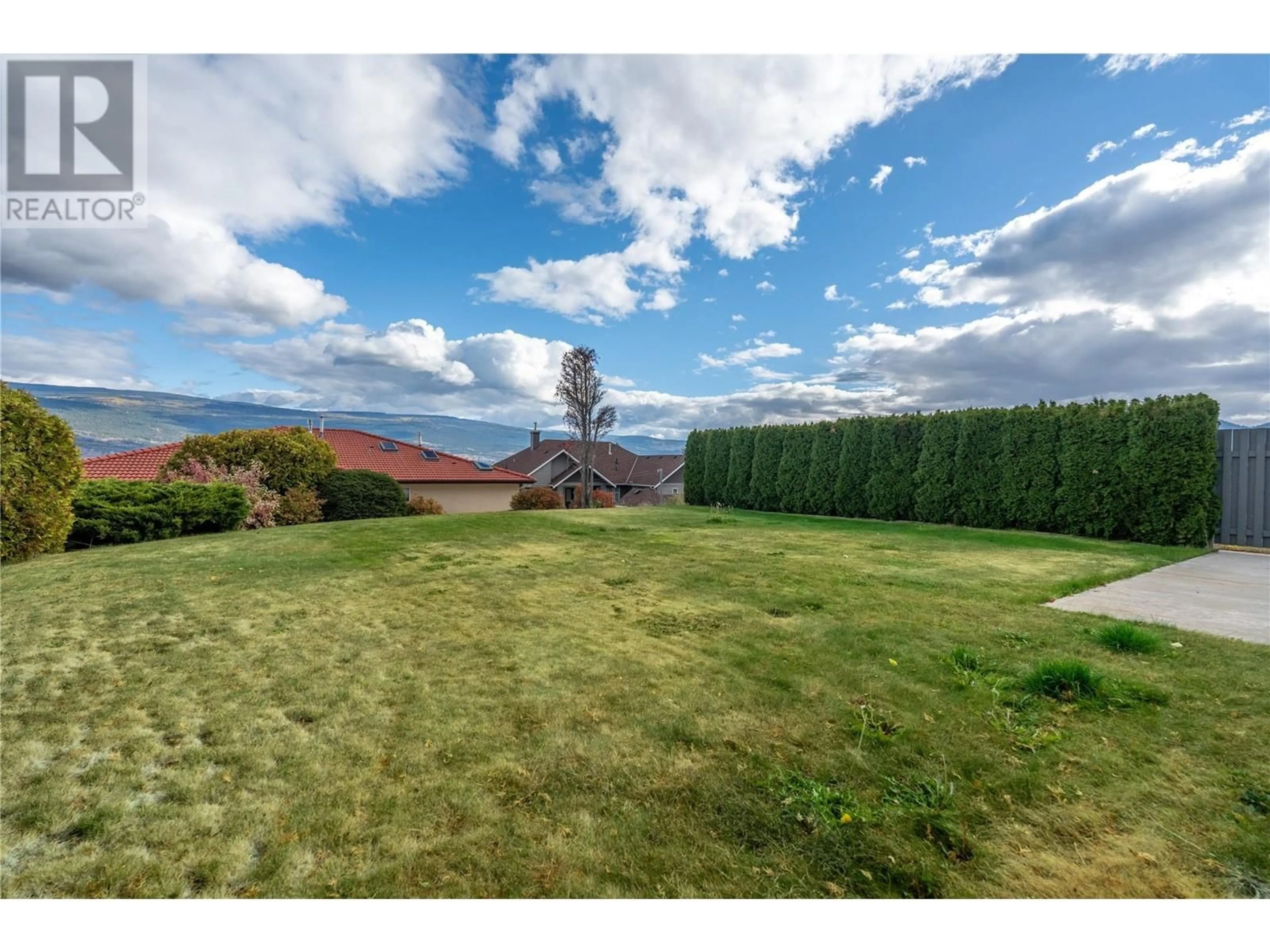 A pic from exterior of the house or condo, the fenced backyard for 6401 Harrison Heights, Summerland British Columbia V0H1Z7