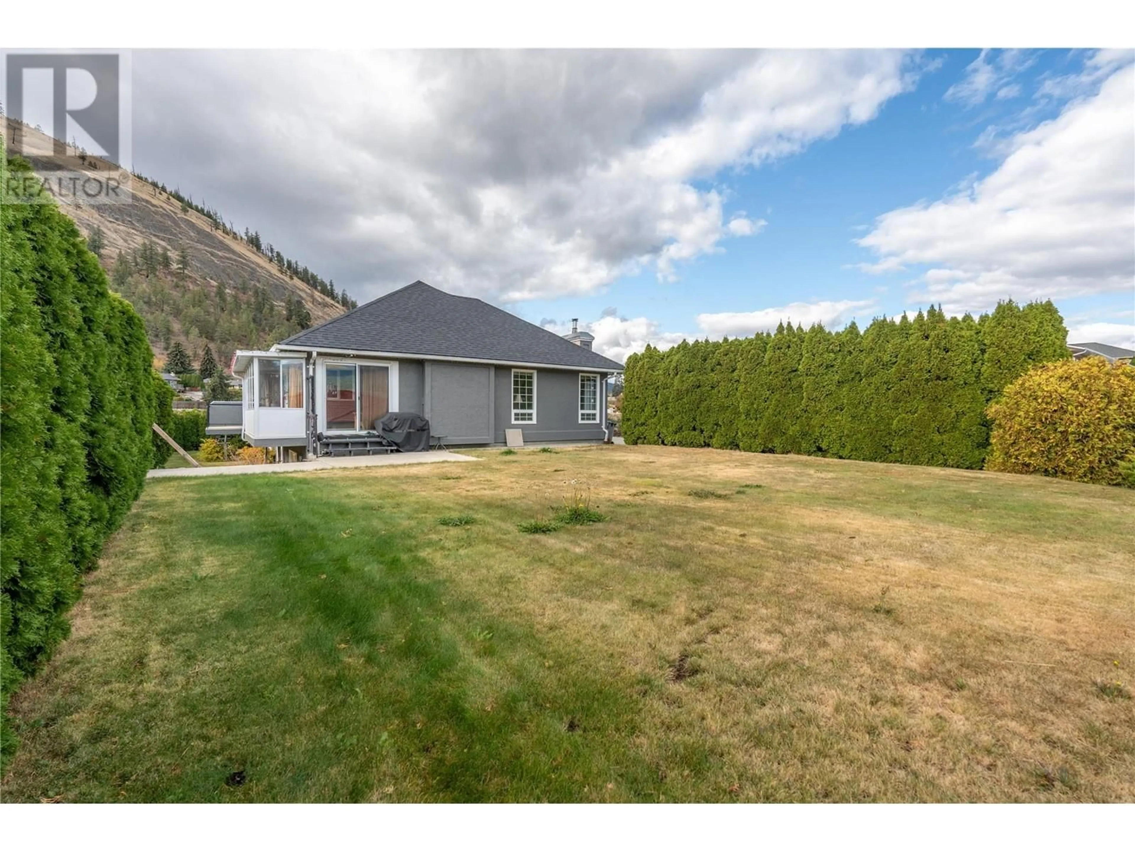 Frontside or backside of a home, the fenced backyard for 6401 Harrison Heights, Summerland British Columbia V0H1Z7