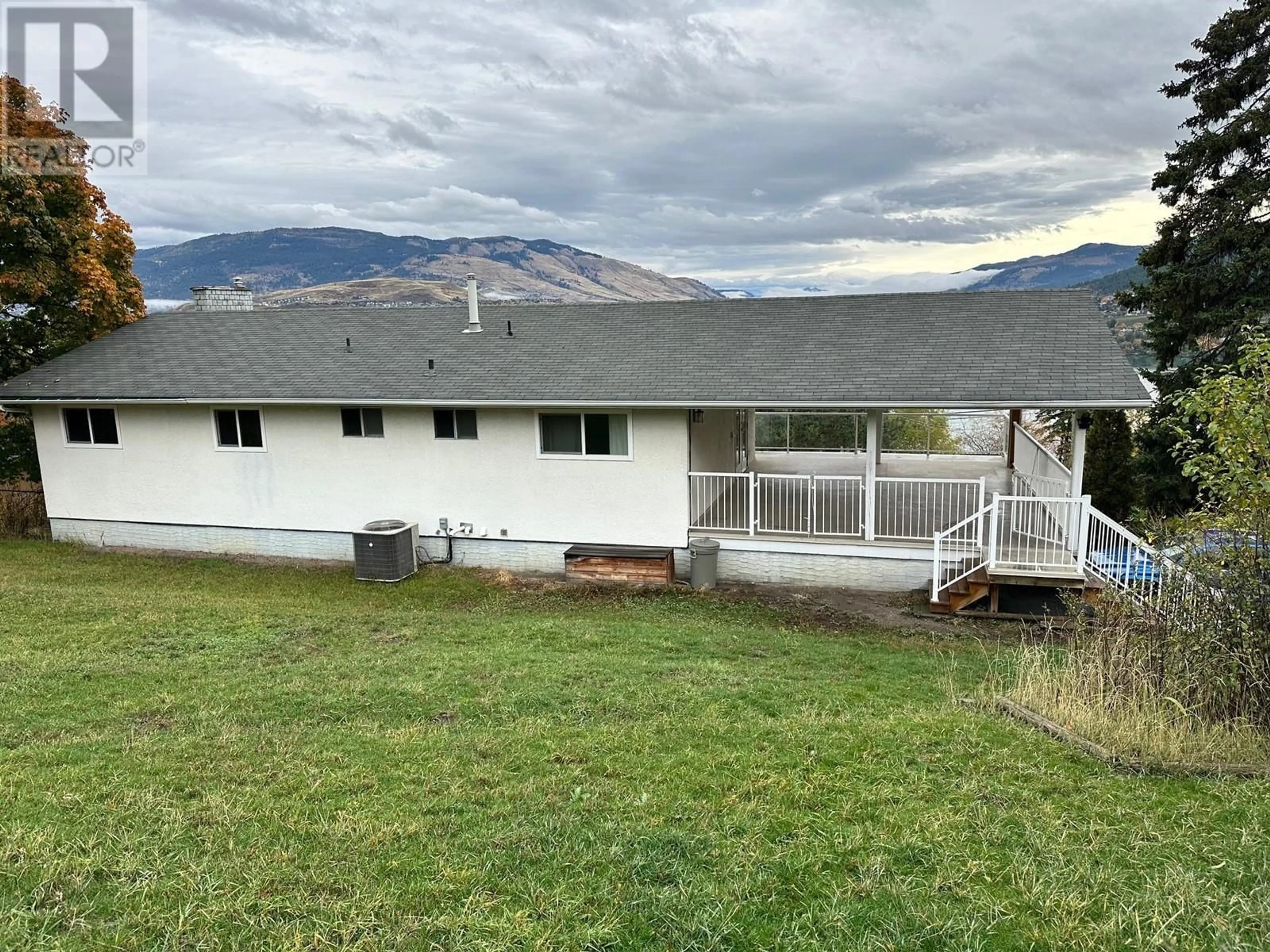 Frontside or backside of a home, the fenced backyard for 7910 Lakeview Drive, Coldstream British Columbia V1B1W3