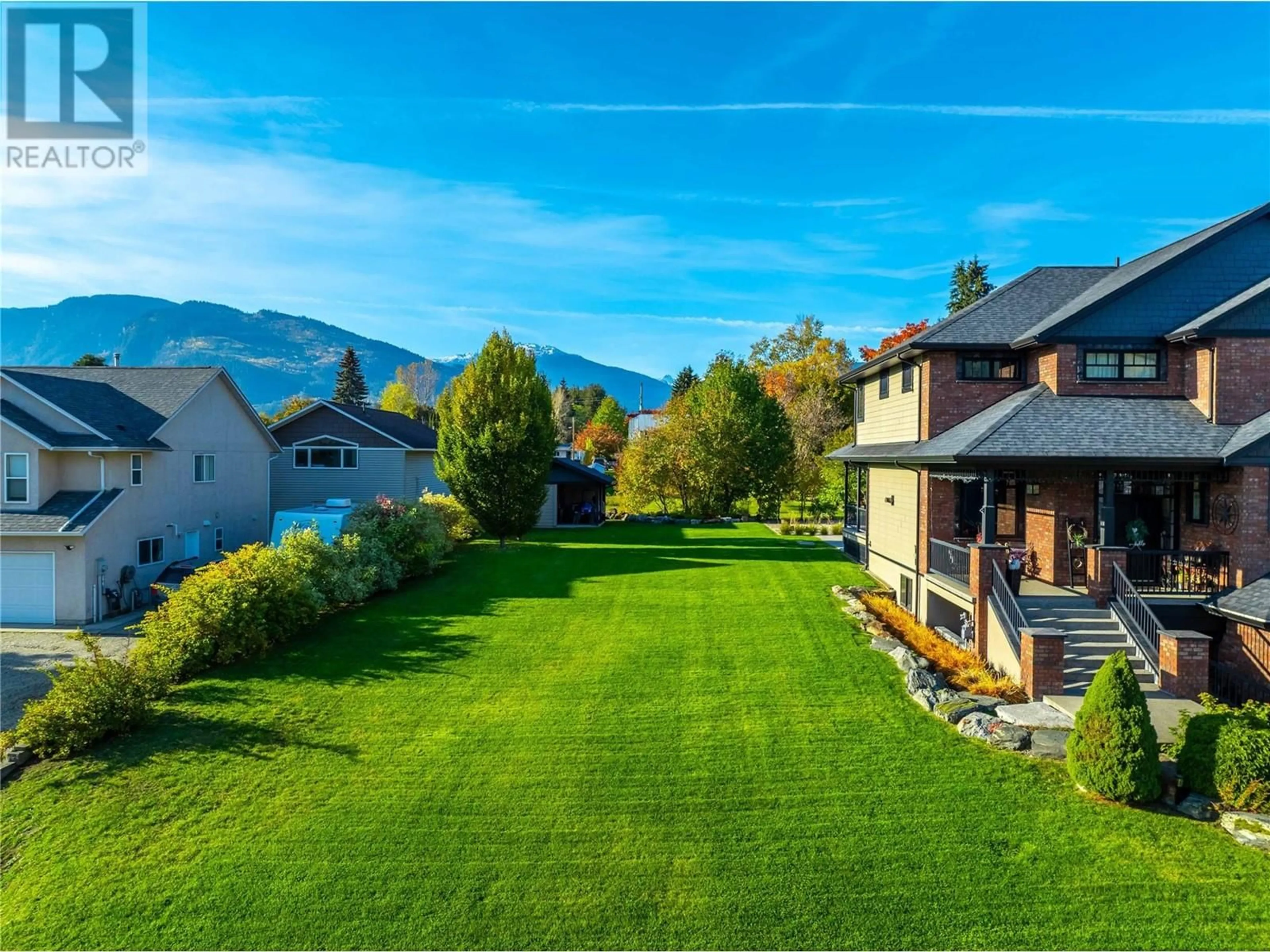 Frontside or backside of a home, the fenced backyard for 905 Edward Street, Revelstoke British Columbia V0E2S0