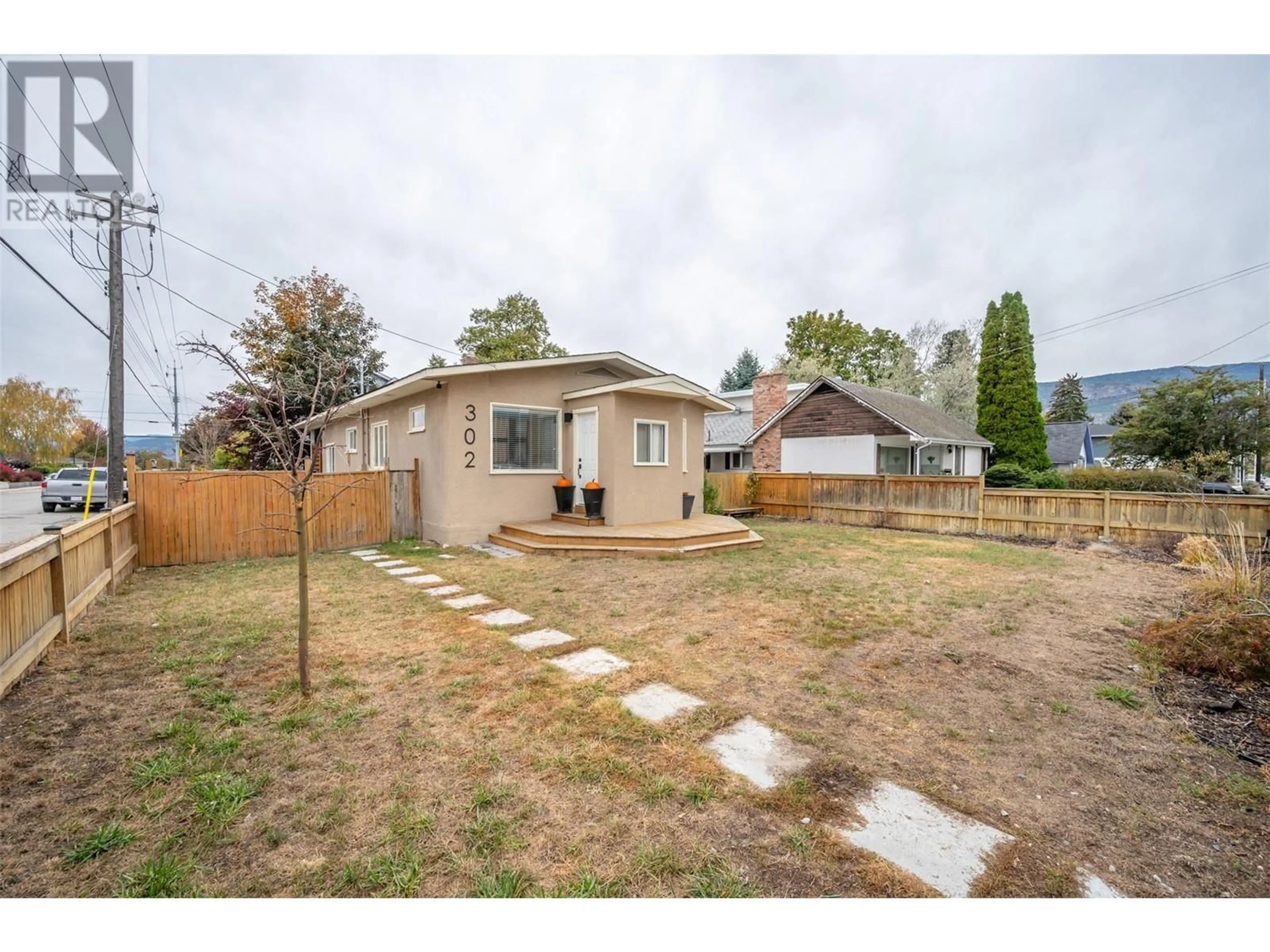 Frontside or backside of a home, the fenced backyard for 302 Scott Avenue, Penticton British Columbia V2A2J8