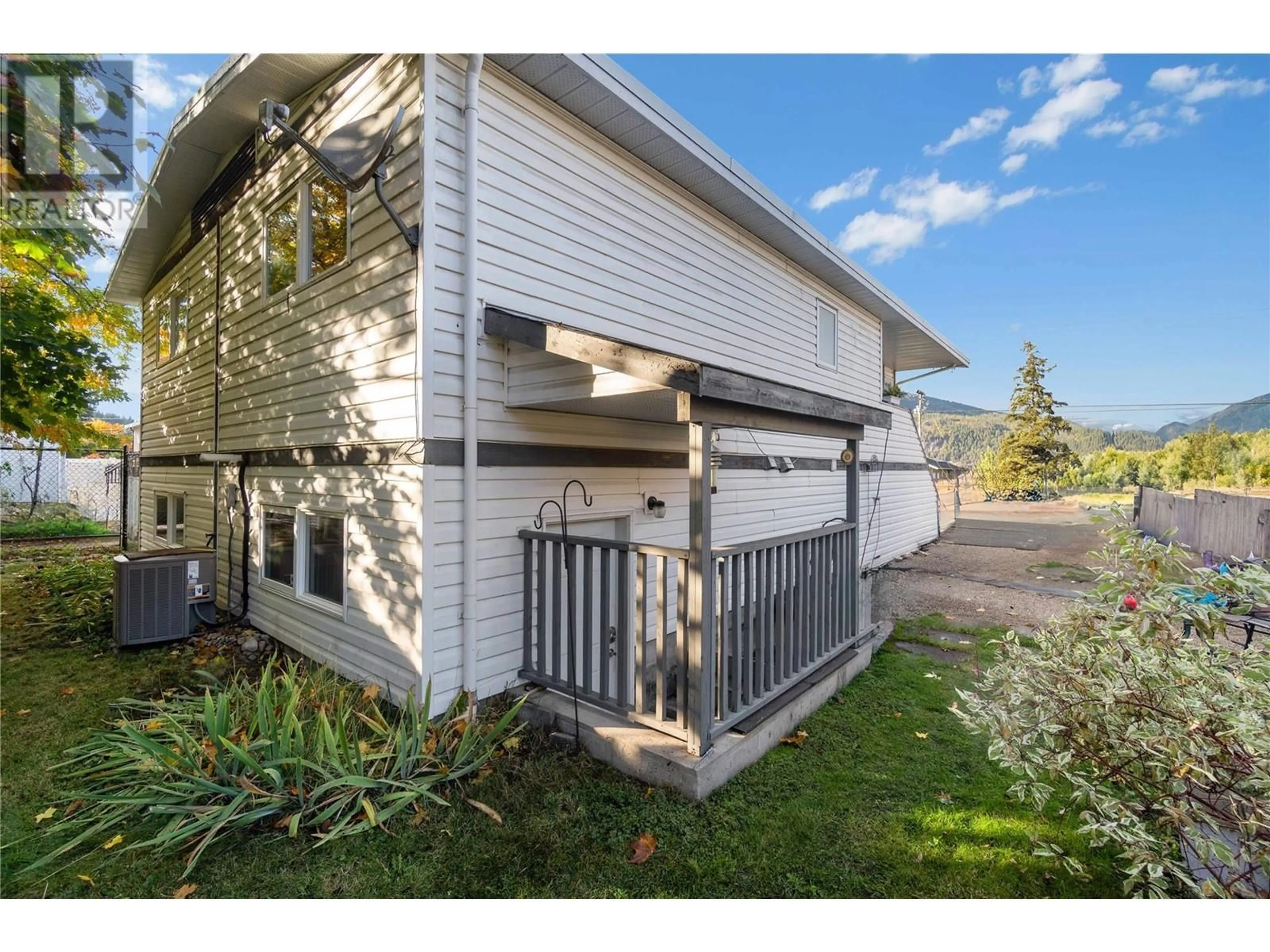 A pic from exterior of the house or condo, the fenced backyard for 5380 Canoe Beach Drive NE, Salmon Arm British Columbia V1E2M5