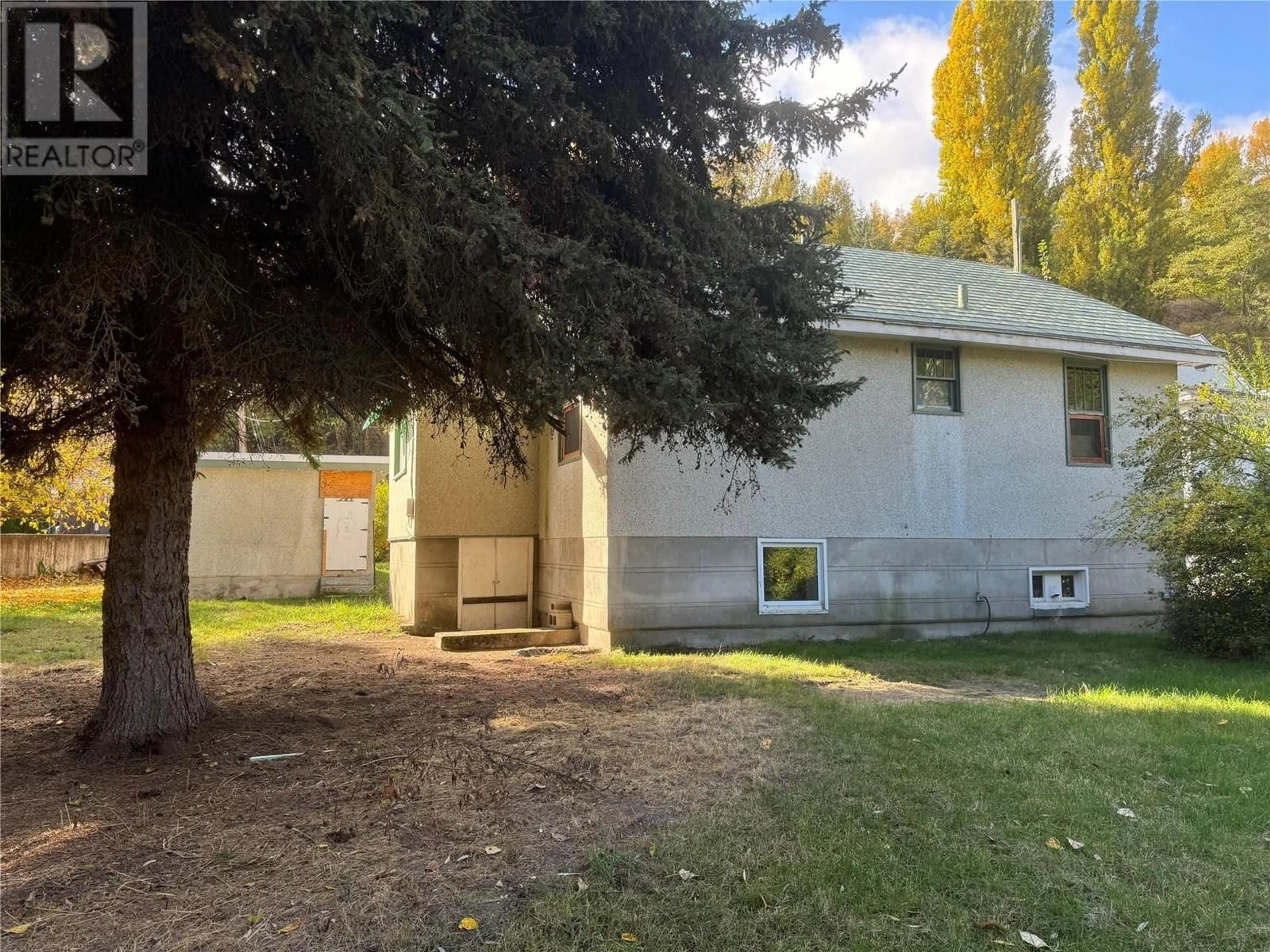 Frontside or backside of a home, the fenced backyard for 193 Wellington Avenue, Warfield British Columbia V1R2K3