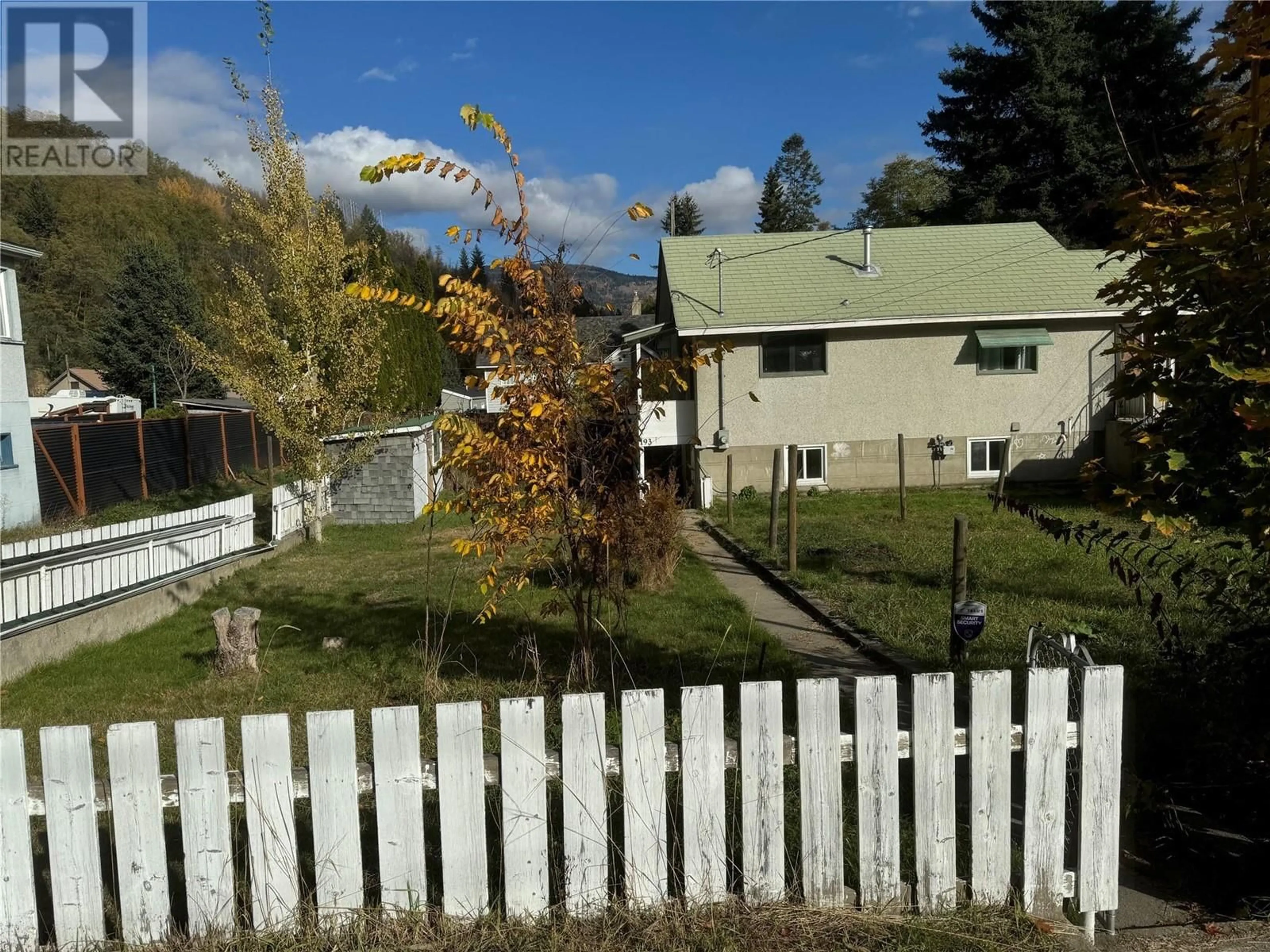 Frontside or backside of a home, the fenced backyard for 193 Wellington Avenue, Warfield British Columbia V1R2K3