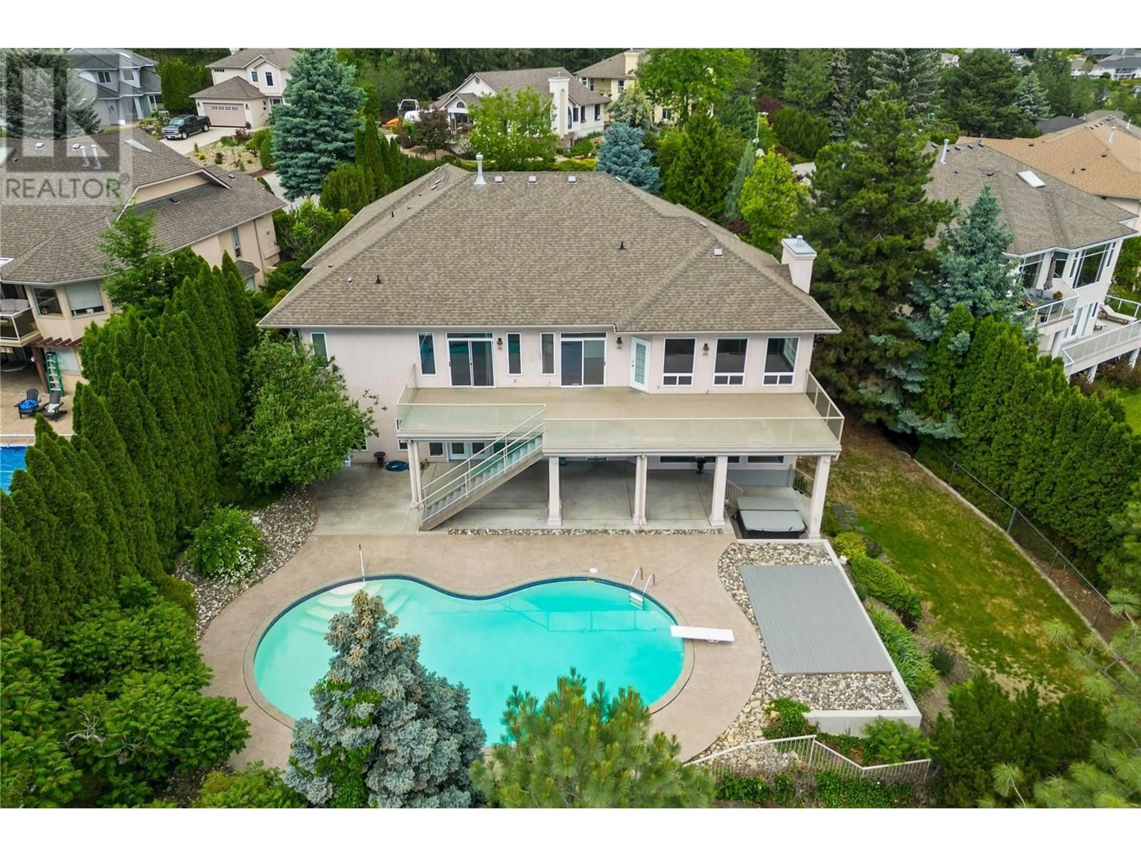 Frontside or backside of a home, the fenced backyard for 947 Purcell Court, Kelowna British Columbia V1V1N7