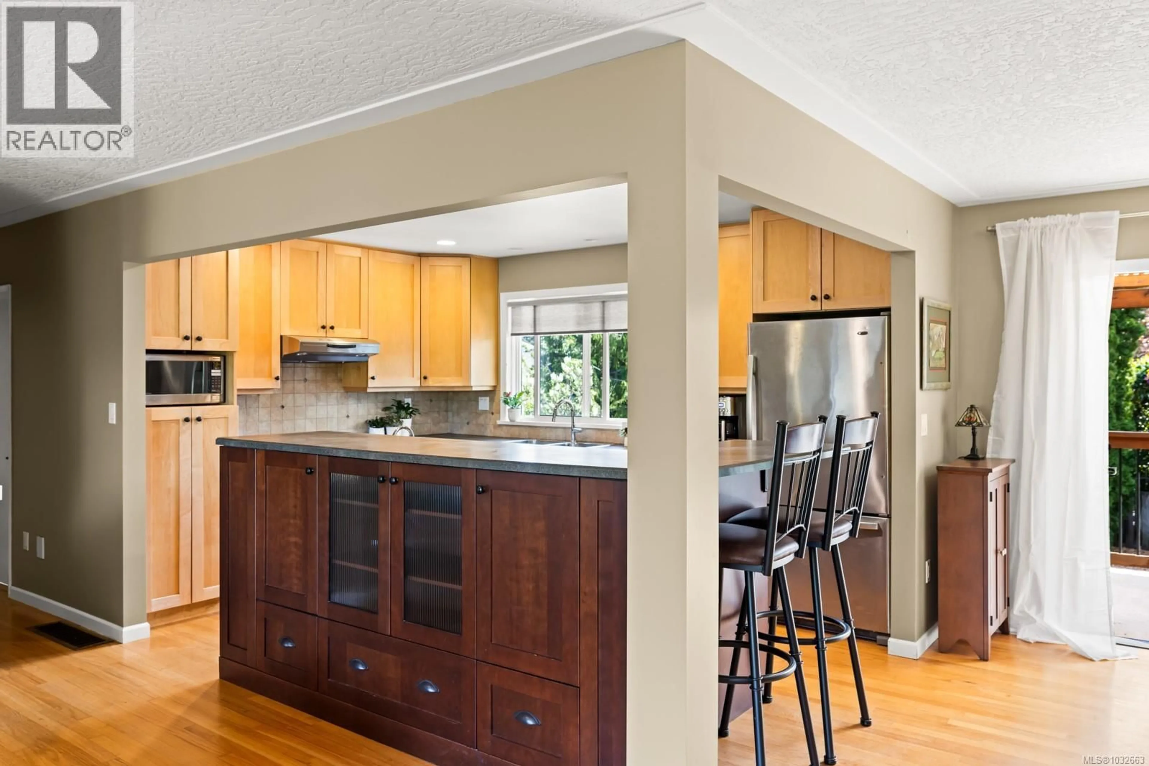 Open concept kitchen, wood/laminate floor for 1897 SAN PEDRO AVENUE, Saanich British Columbia V8N2G7
