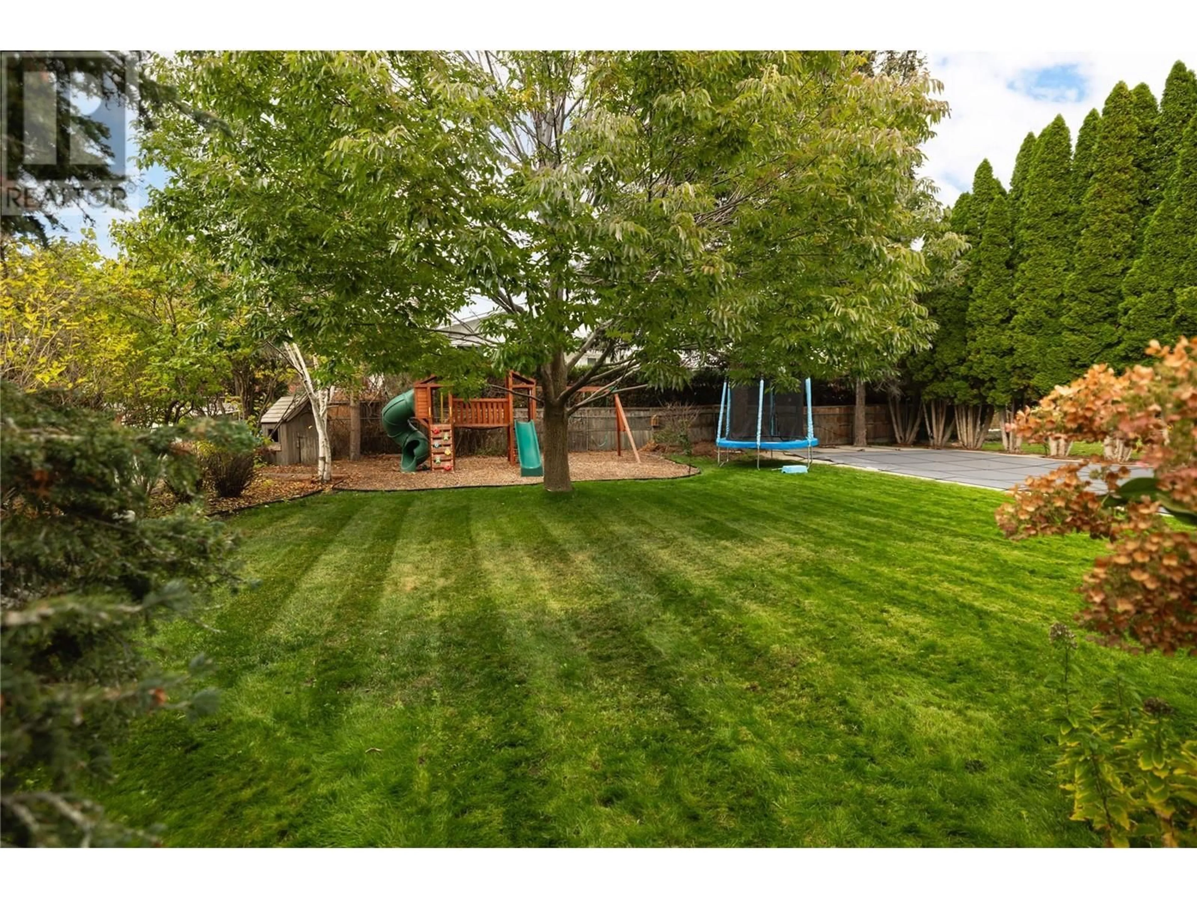 A pic from exterior of the house or condo, the fenced backyard for 590 Hardie Road, Kelowna British Columbia v1x6e1